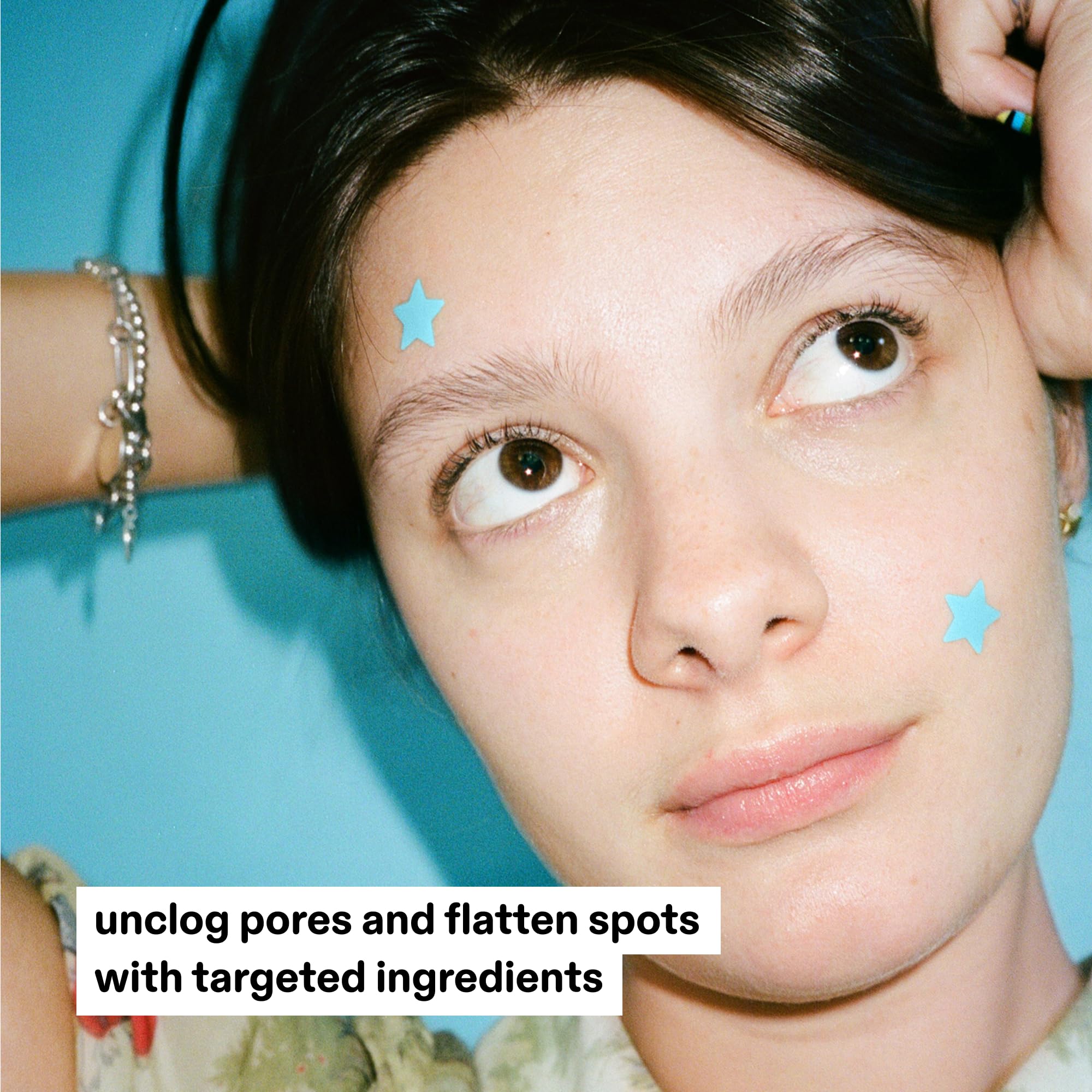 Star shaped blue hydrocolloid acne patches inside the open mirrored reusable case