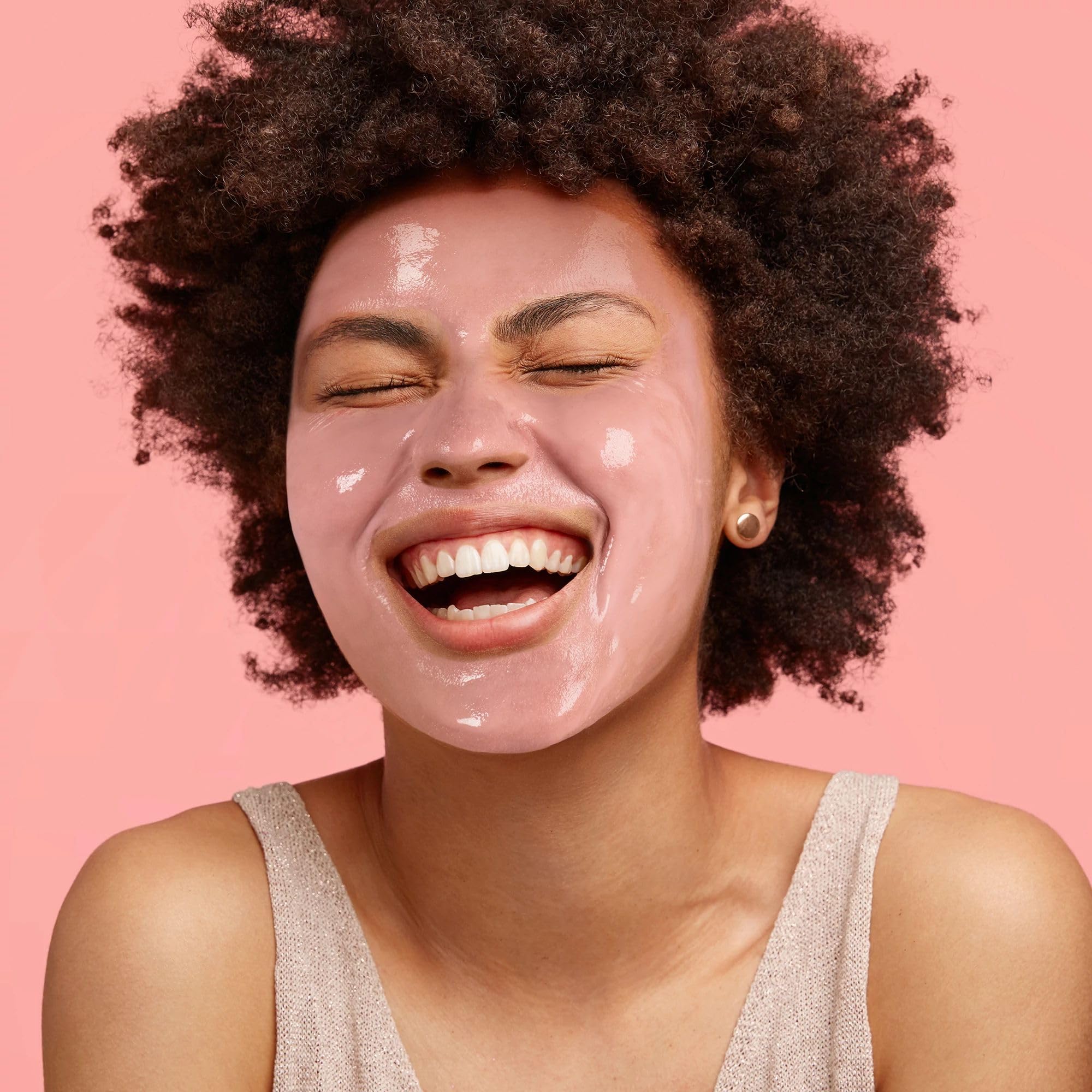 Applying Freeman pink clay mask on skin