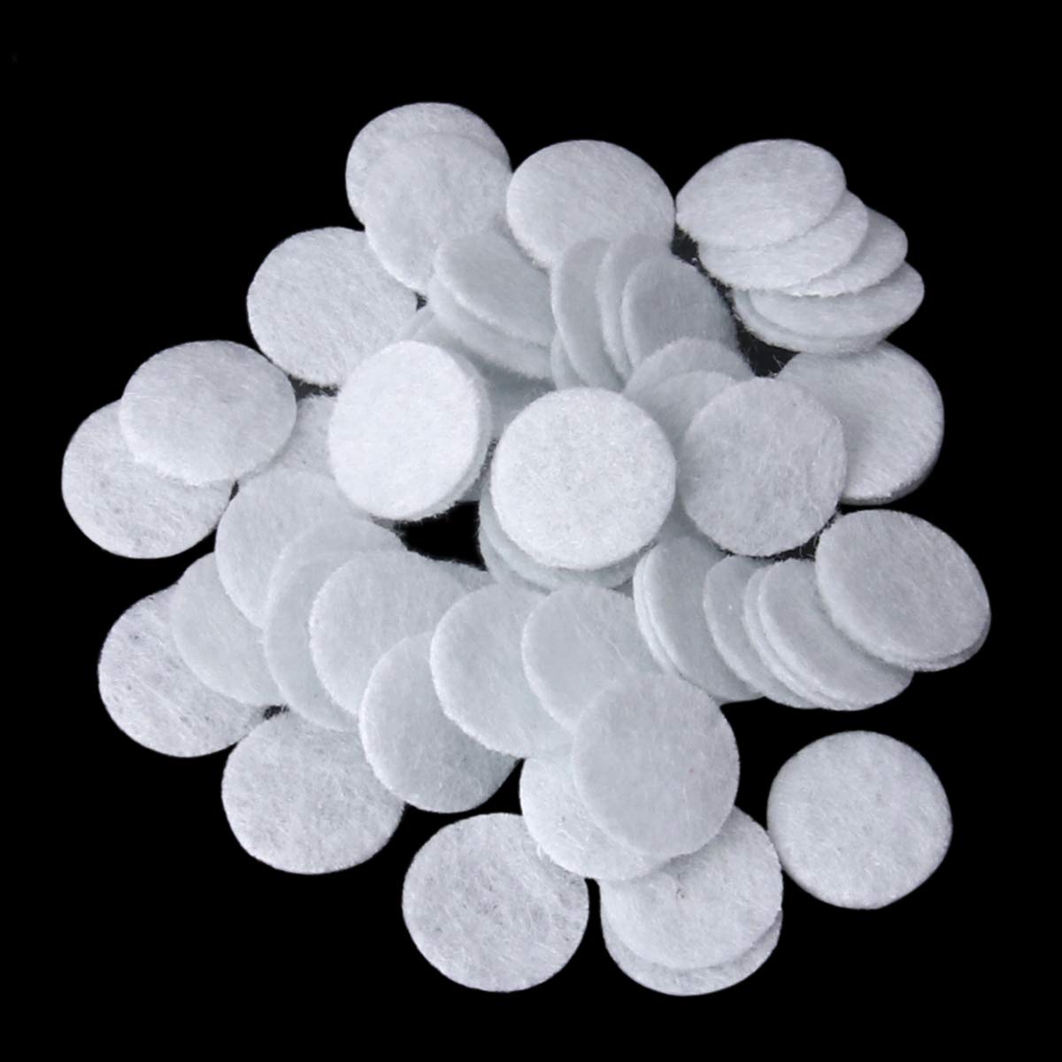 Ten millimeter diamond dermabrasion sponge filters arranged to demonstrate thickness and diameter.