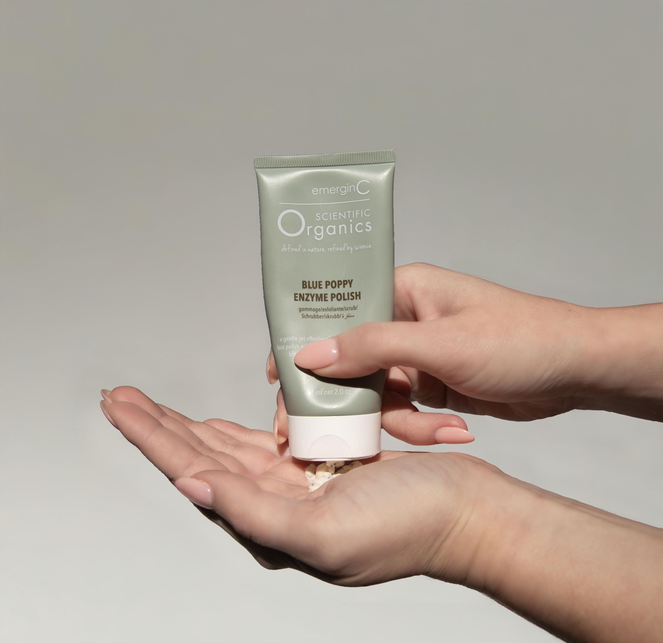 Texture shot of the exfoliating face scrub showing blue poppy seeds blended in a smooth base.