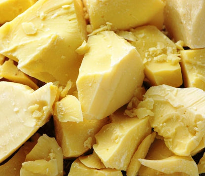 Close up of nutrient rich raw unrefined shea butter scoop