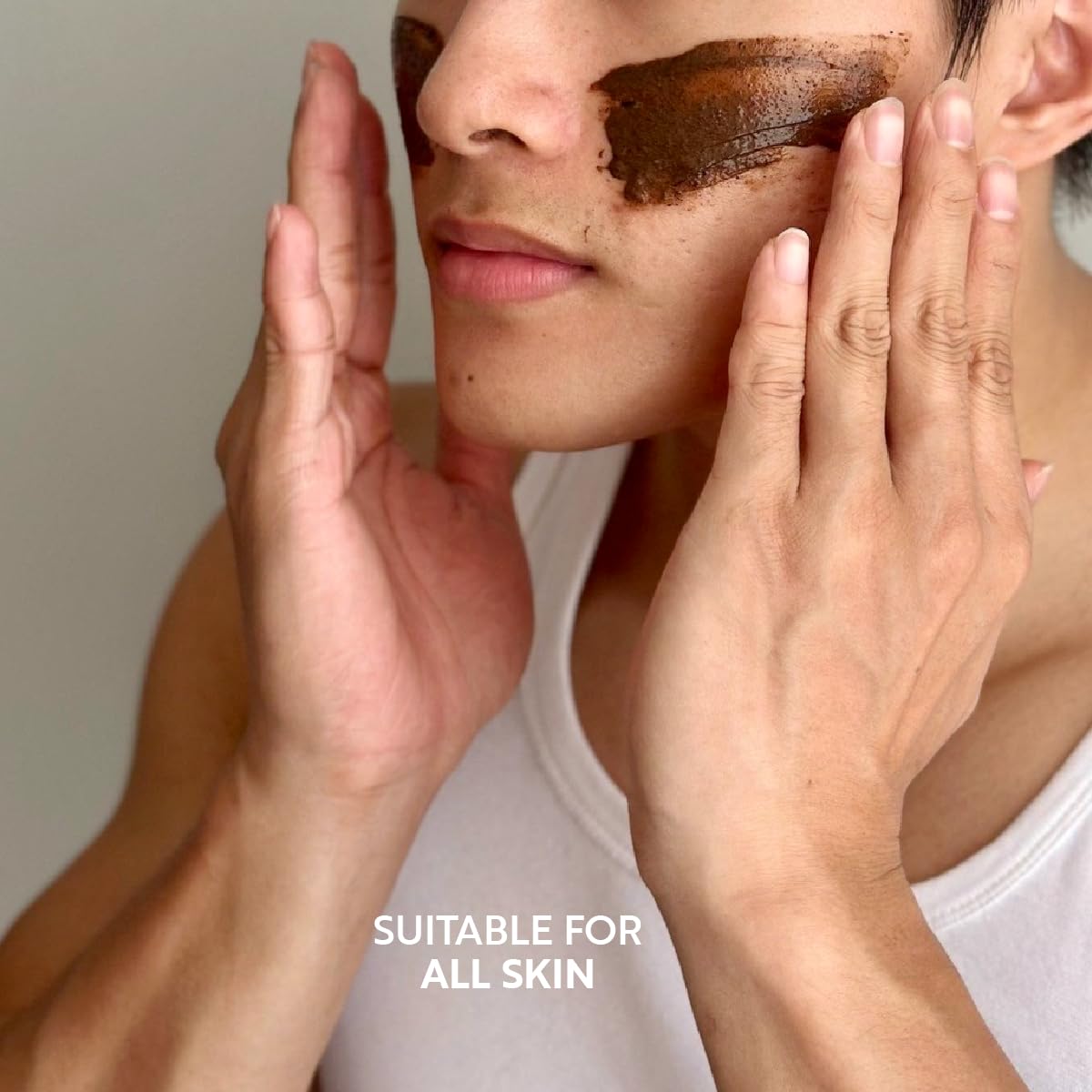 Applying Cocoon coffee face polish to damp skin