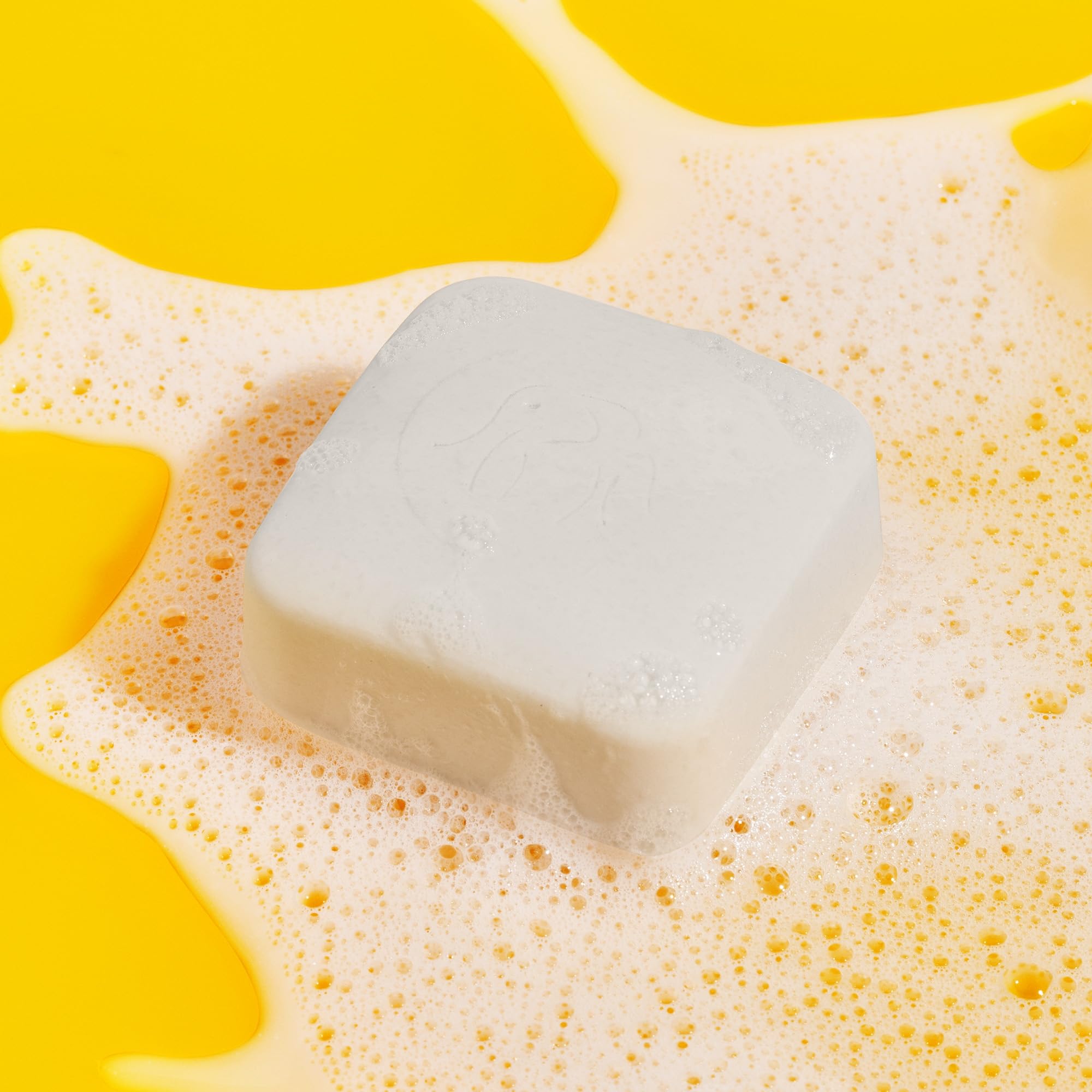 Drunk Elephant Pekee Bar four ounce size showing product texture and logo.