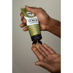 SoftSheen-Carson Magic Men's Grooming Facial Exfoliating Scrub dispensing product on palm