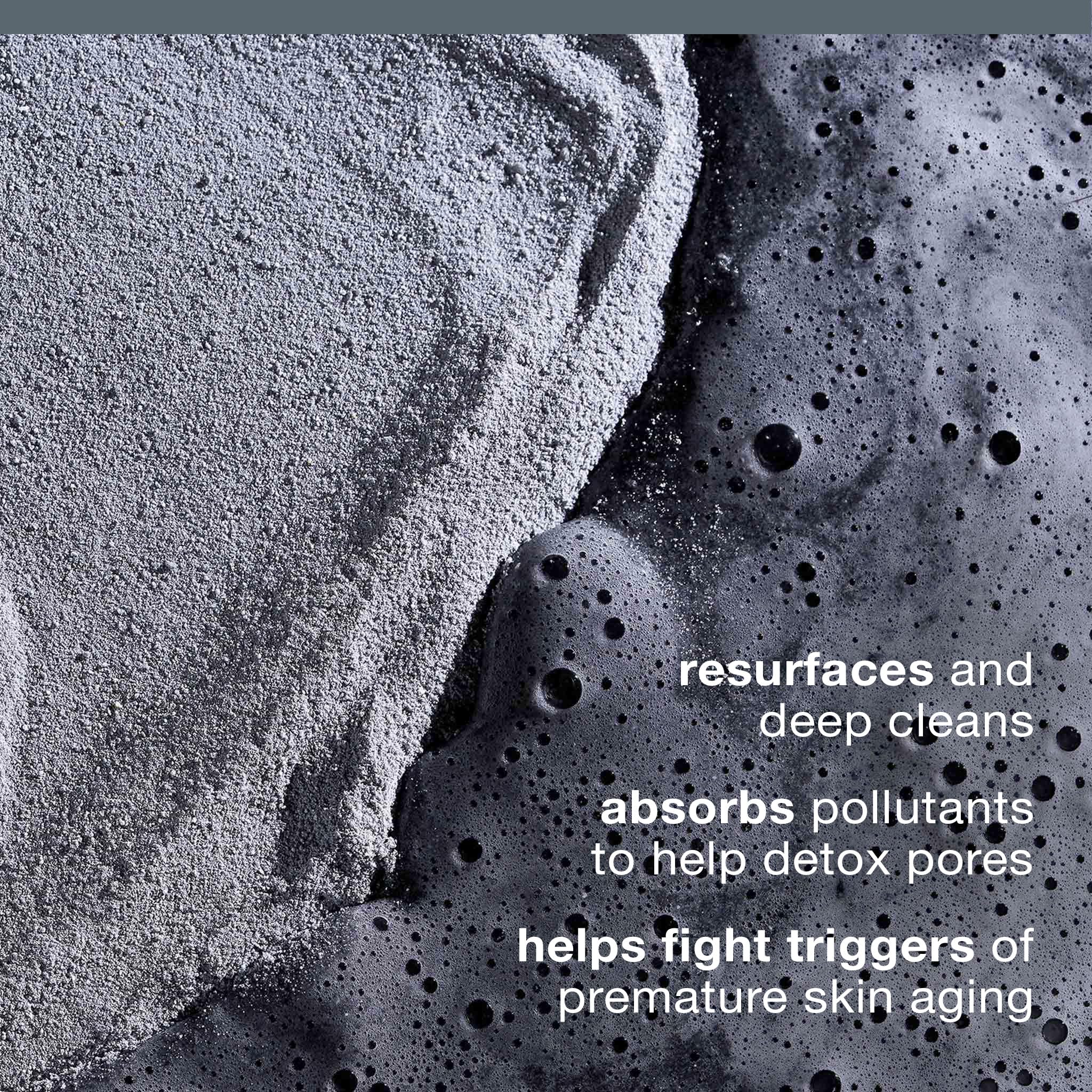 Dermalogica activated charcoal face scrub powder being dispensed into wet hands