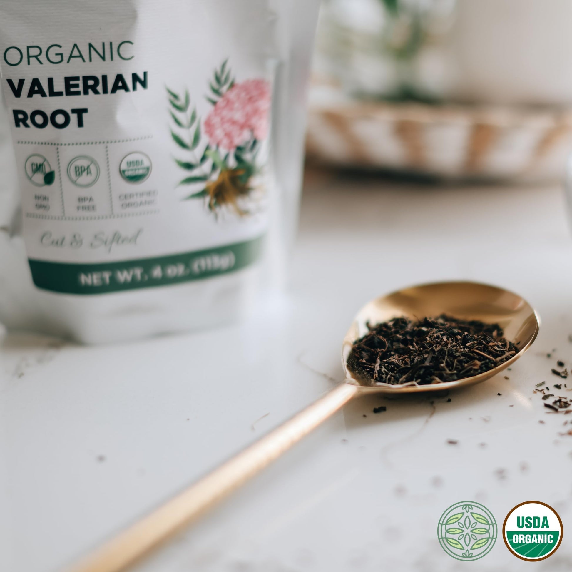 Measuring a spoonful of dried organic valerian root for brewing natural relaxation herbal tea infusions.