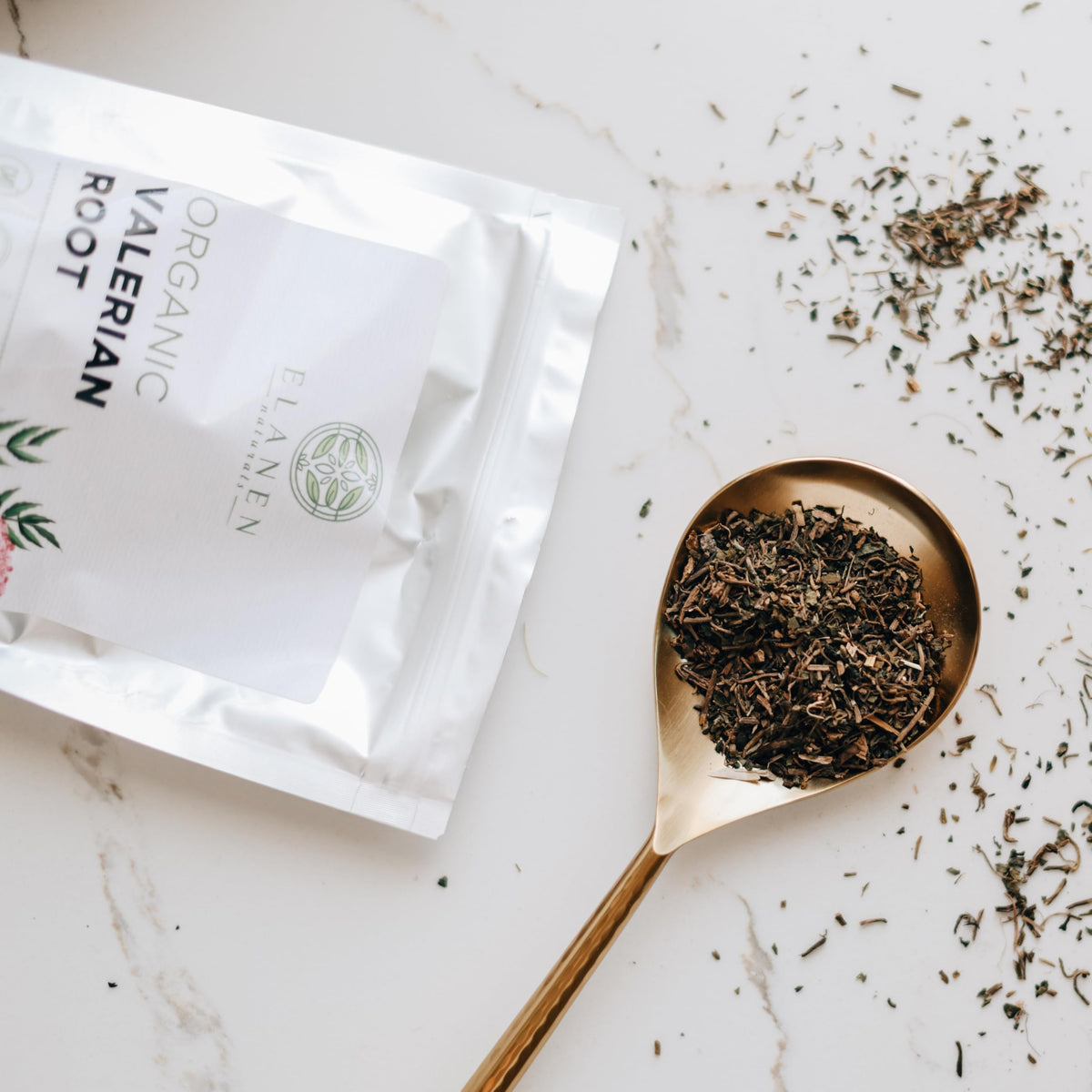 Organic valerian root cut pieces inside a tea infuser demonstrating proper preparation step for sleep support.