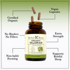 Herbal Roots organic valerian root capsules spilled next to the amber glass bottle showing vegan pills