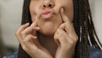 The Body Shop Mango Lip Butter lifestyle shot on vanity