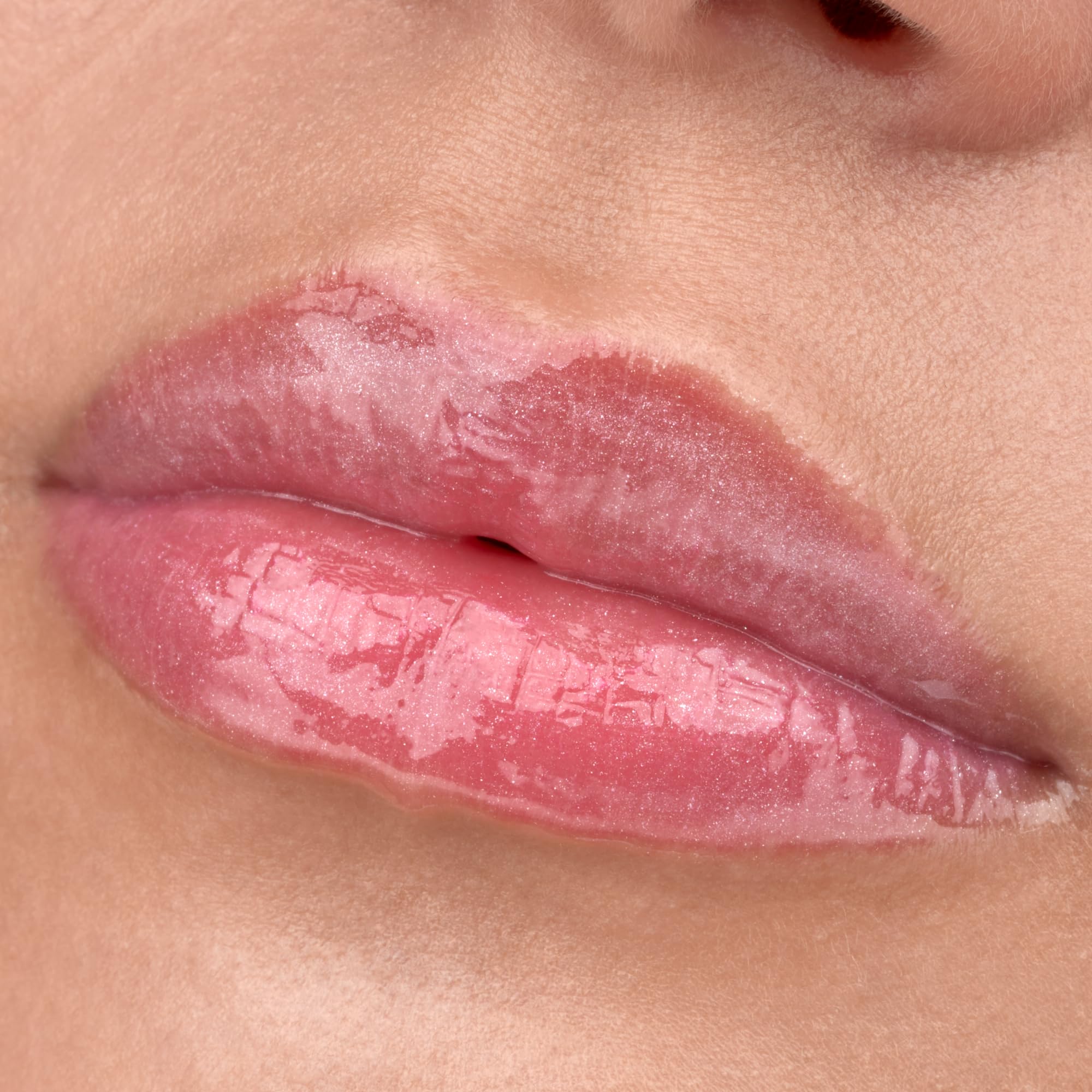 Lip gloss swatch showing translucent pearly texture