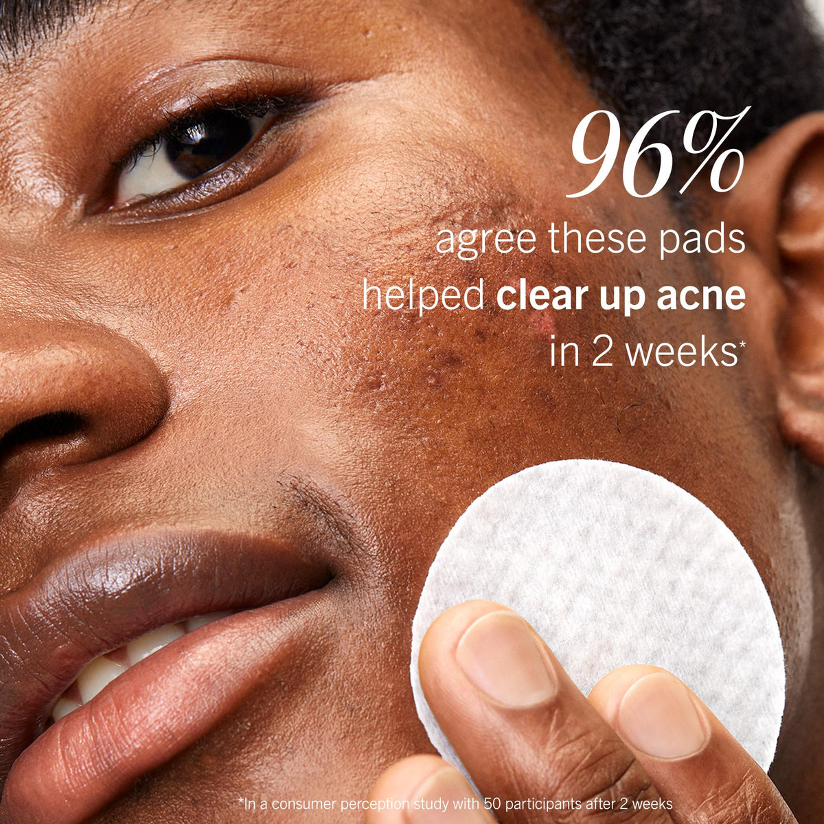 Textured pre-soaked facial pad held up to showcase material quality
