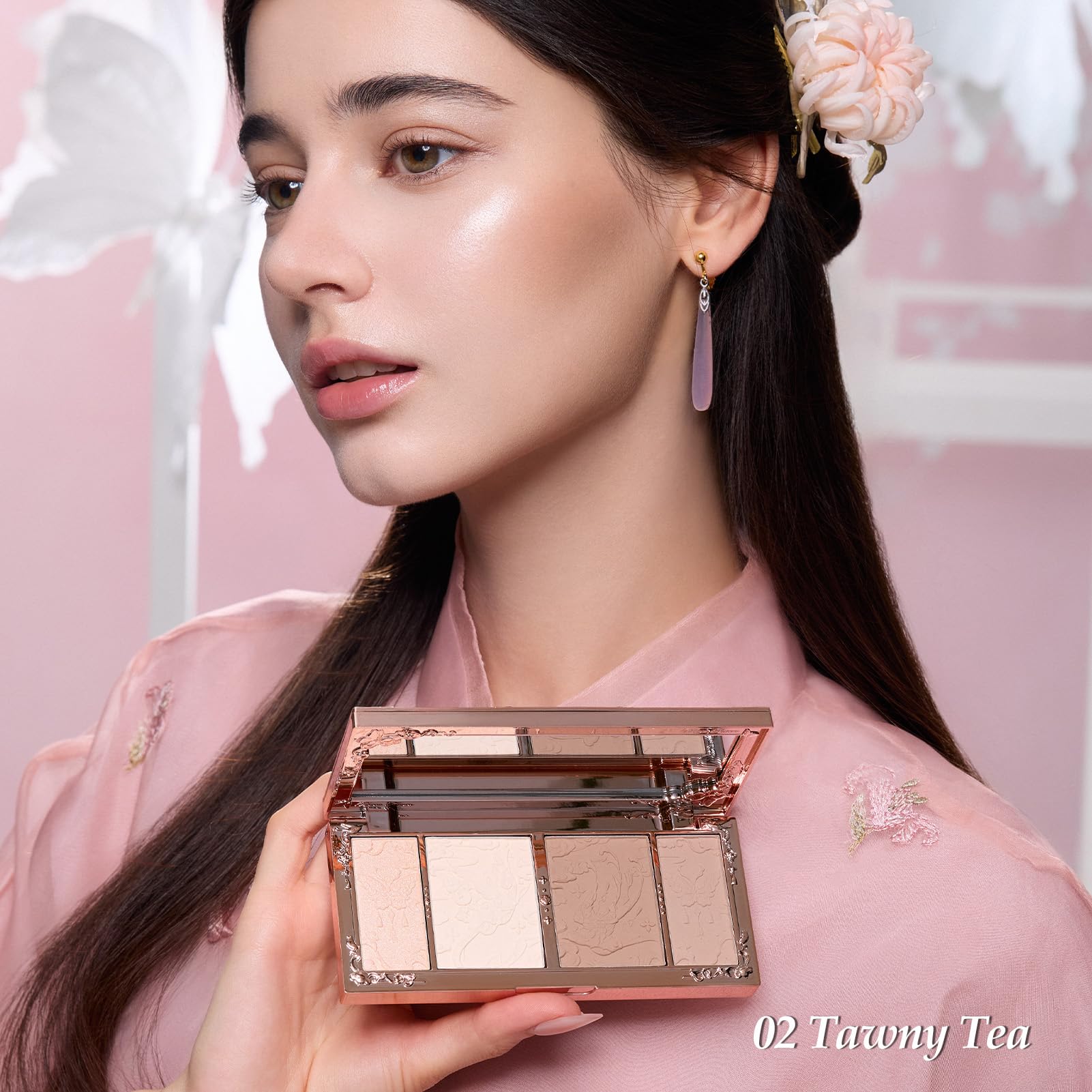Top view of the luxury imported embossed highlighter and contour compact with built in mirror.