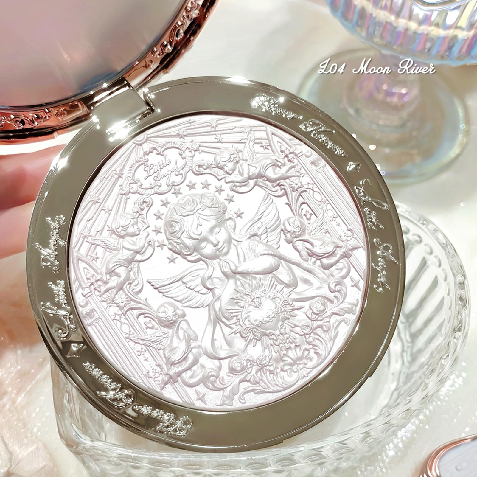 Long lasting ethereal starry glow highlighter palette displaying intricate angel artwork