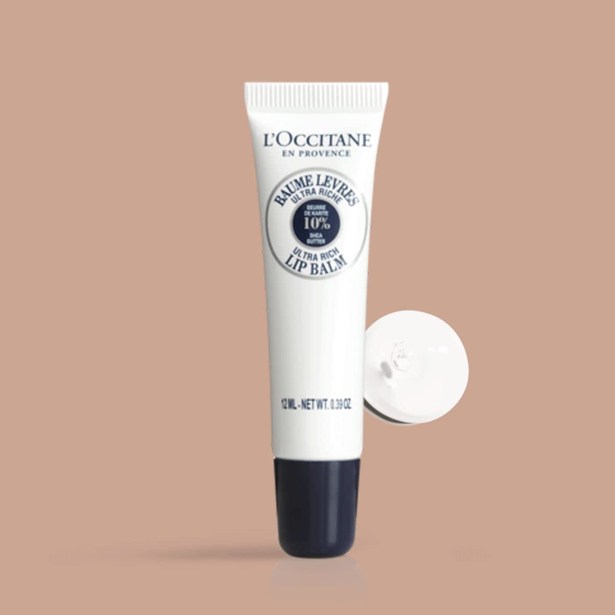 L'Occitane 10 percent shea butter nourishing lip cream tube on plain background