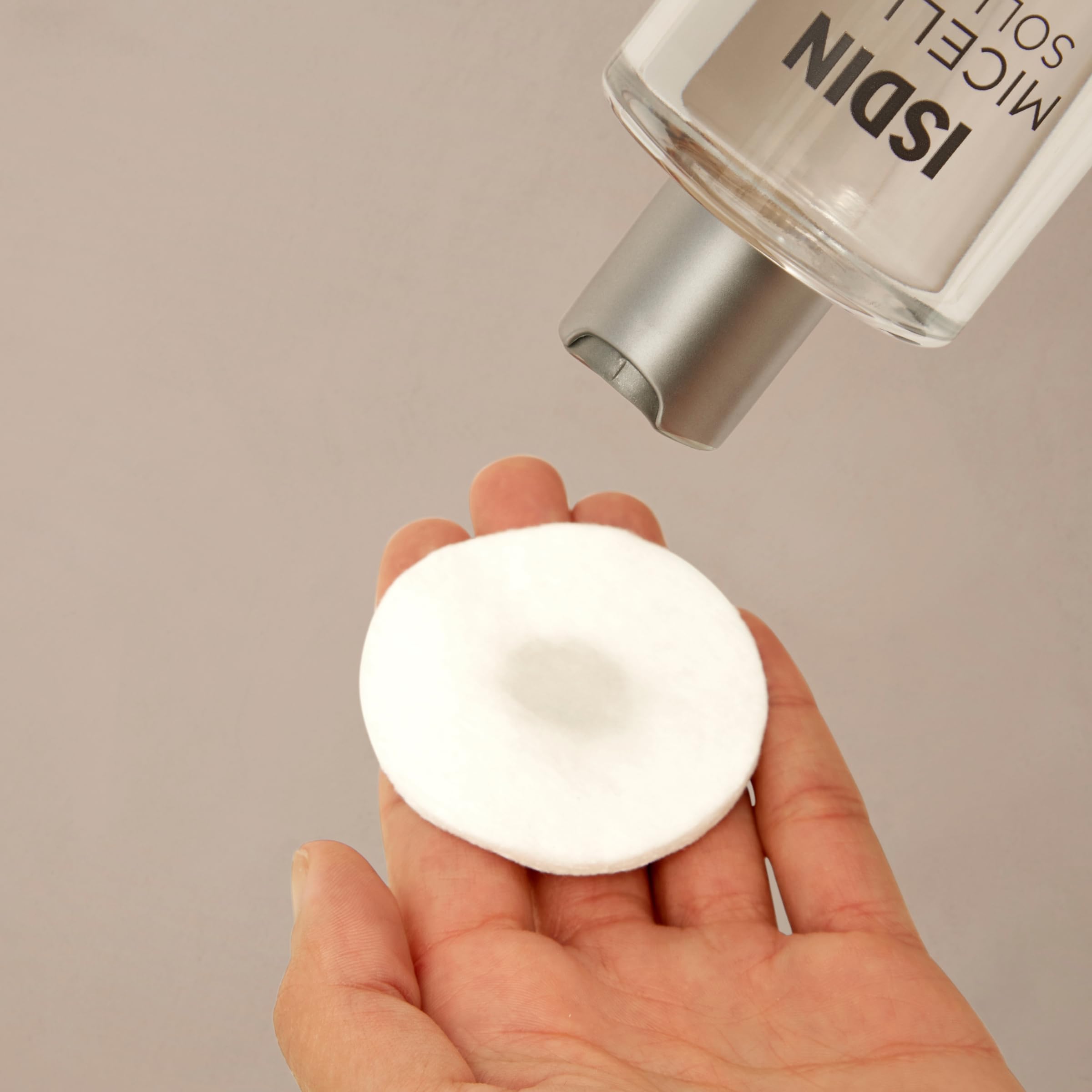 ISDIN 4-in-1 makeup remover and hydrating toner bottle showing clear liquid solution