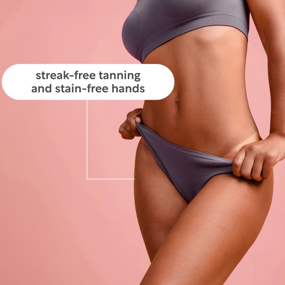 Applying self-tanner to the body using a professional-grade Lucy Bee mitt