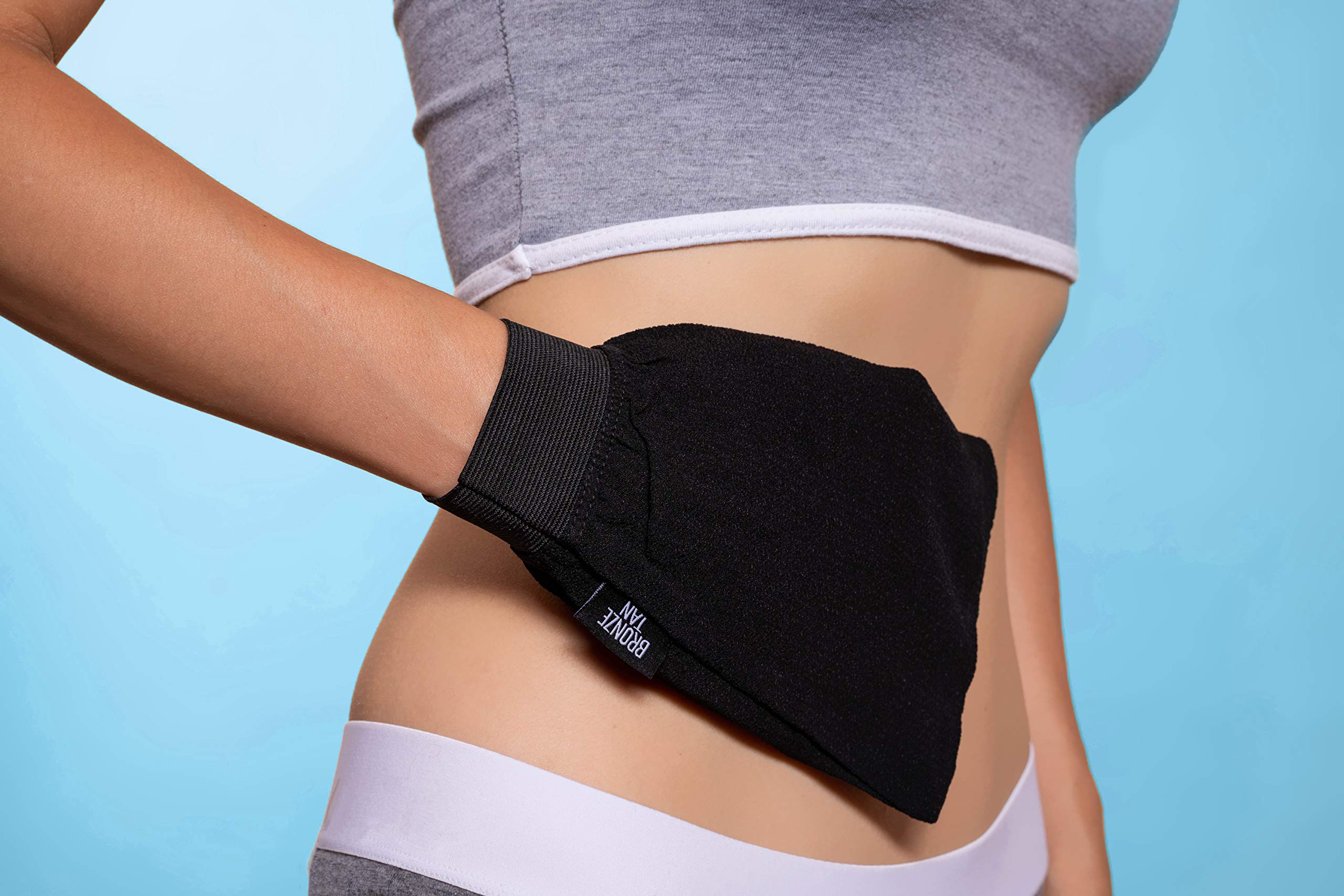 Existing Beauty exfoliating glove being used on arm