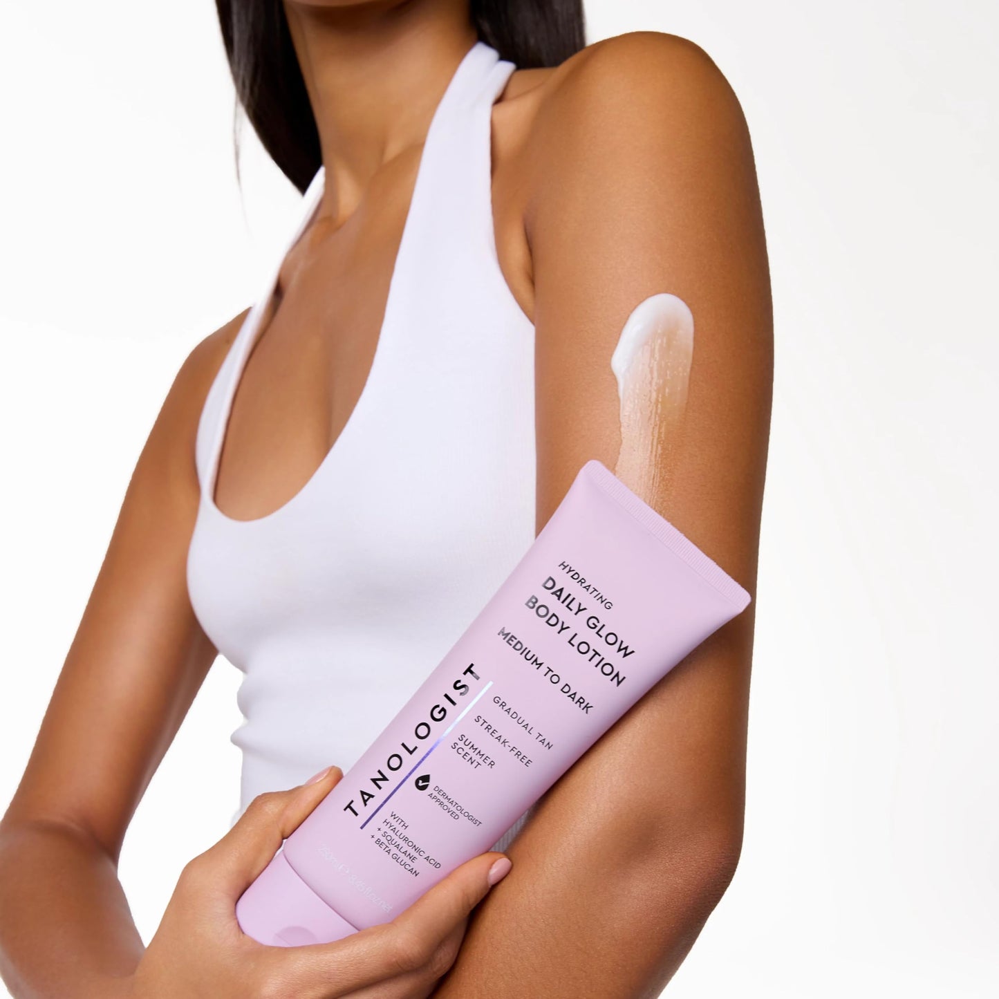 Tanologist gradual tan lotion bottle held in hand