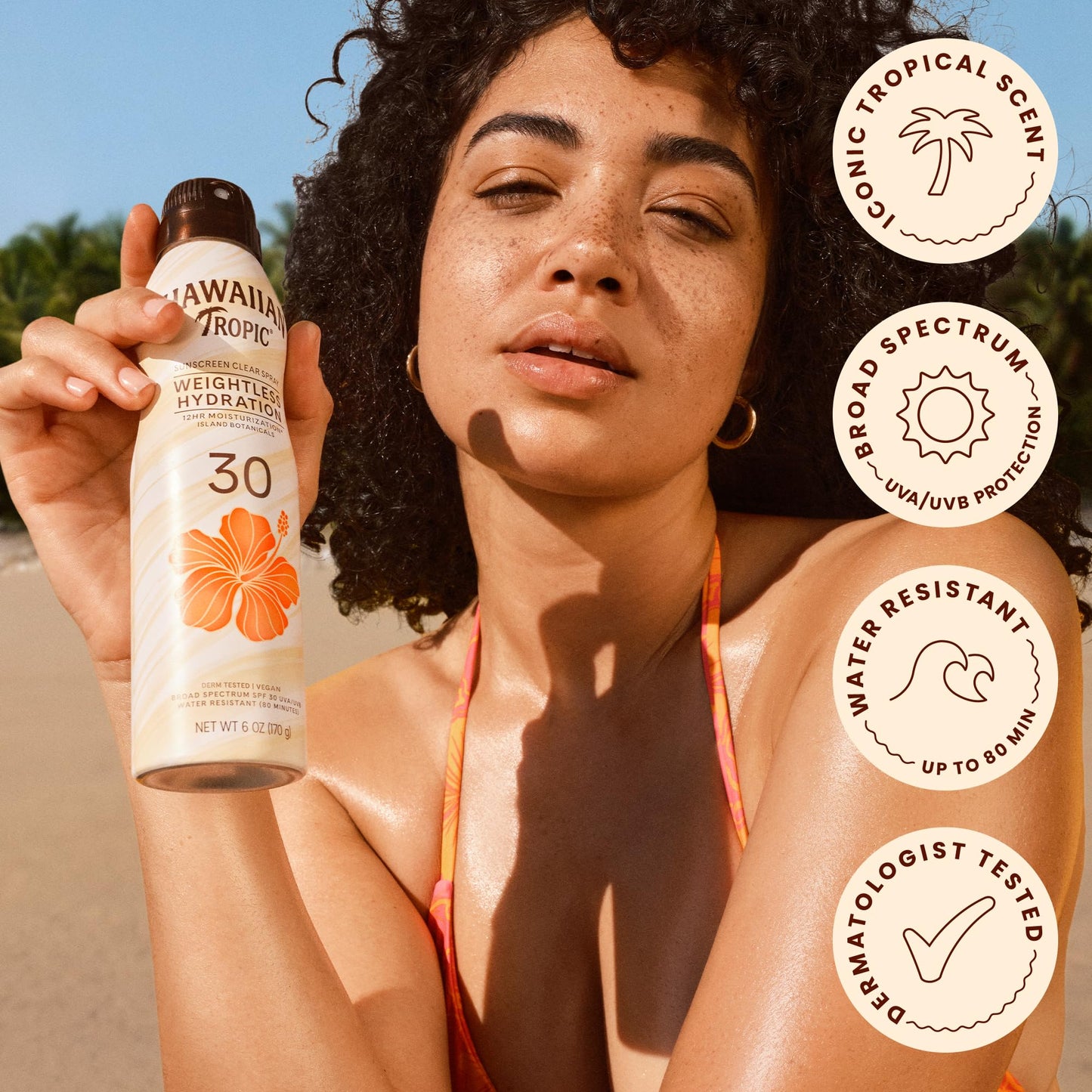 Side view of Hawaiian Tropic clear spray bottle highlighting weightless formula