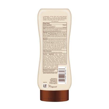 Hawaiian Tropic sunscreen bottle held in hand for scale