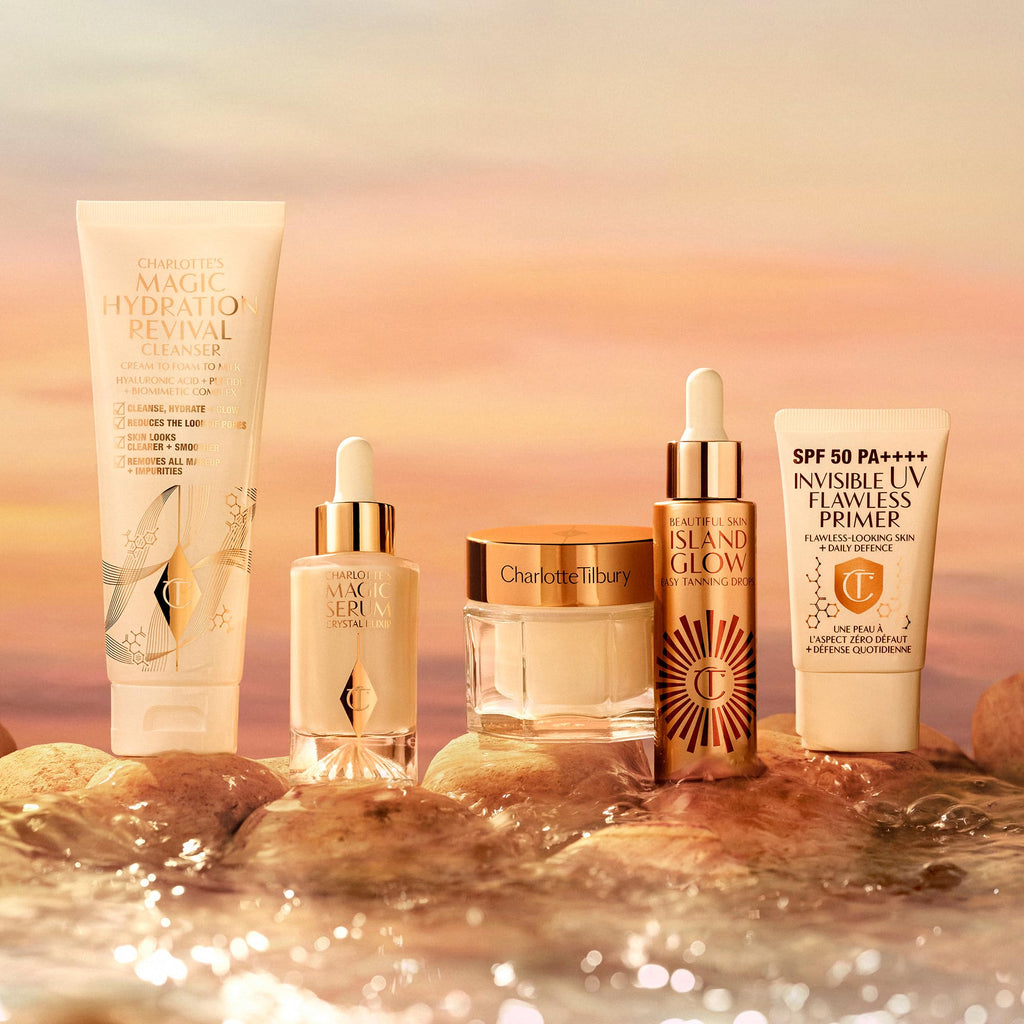 Overhead arrangement of Charlotte Tilbury beauty product and dropper