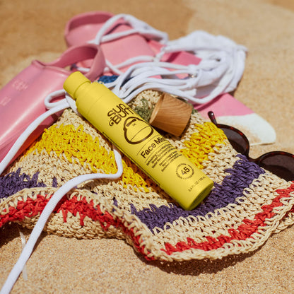 Travel-size Sun Bum sunscreen bottle in a makeup bag