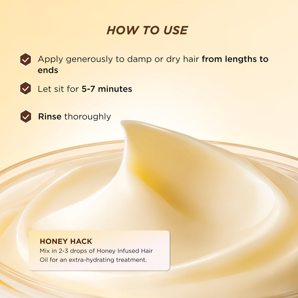 Gisou honey gloss ceramide therapy hair mask held in hand