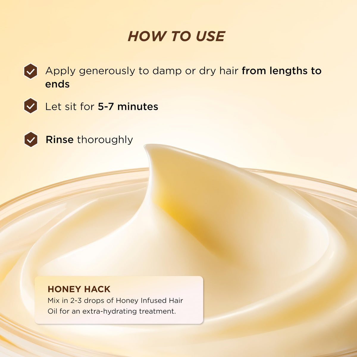 Gisou honey gloss ceramide therapy hair mask held in hand