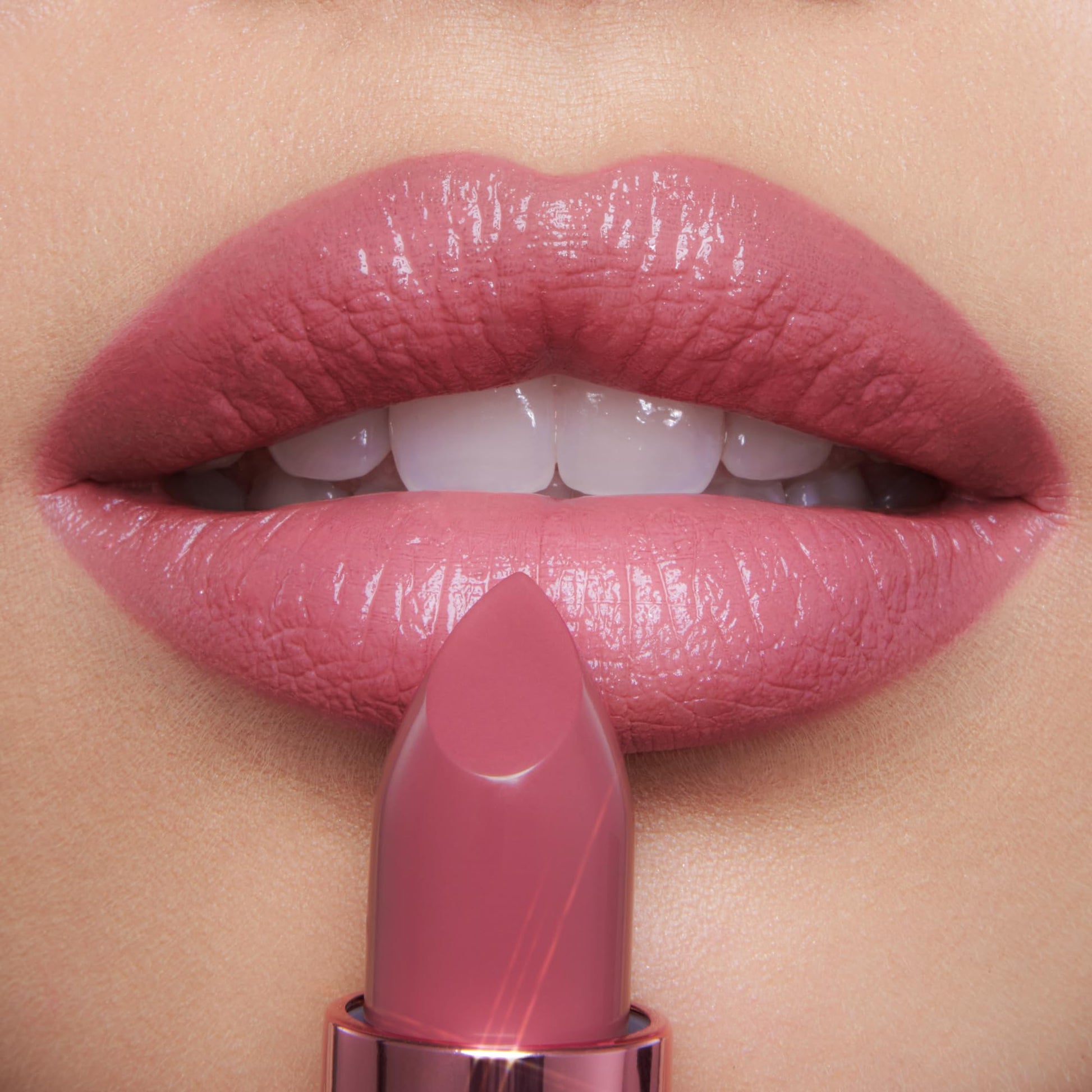 Charlotte Tilbury Icon Baby shimmering nude-rose moisturizing lipstick for full looking lips.