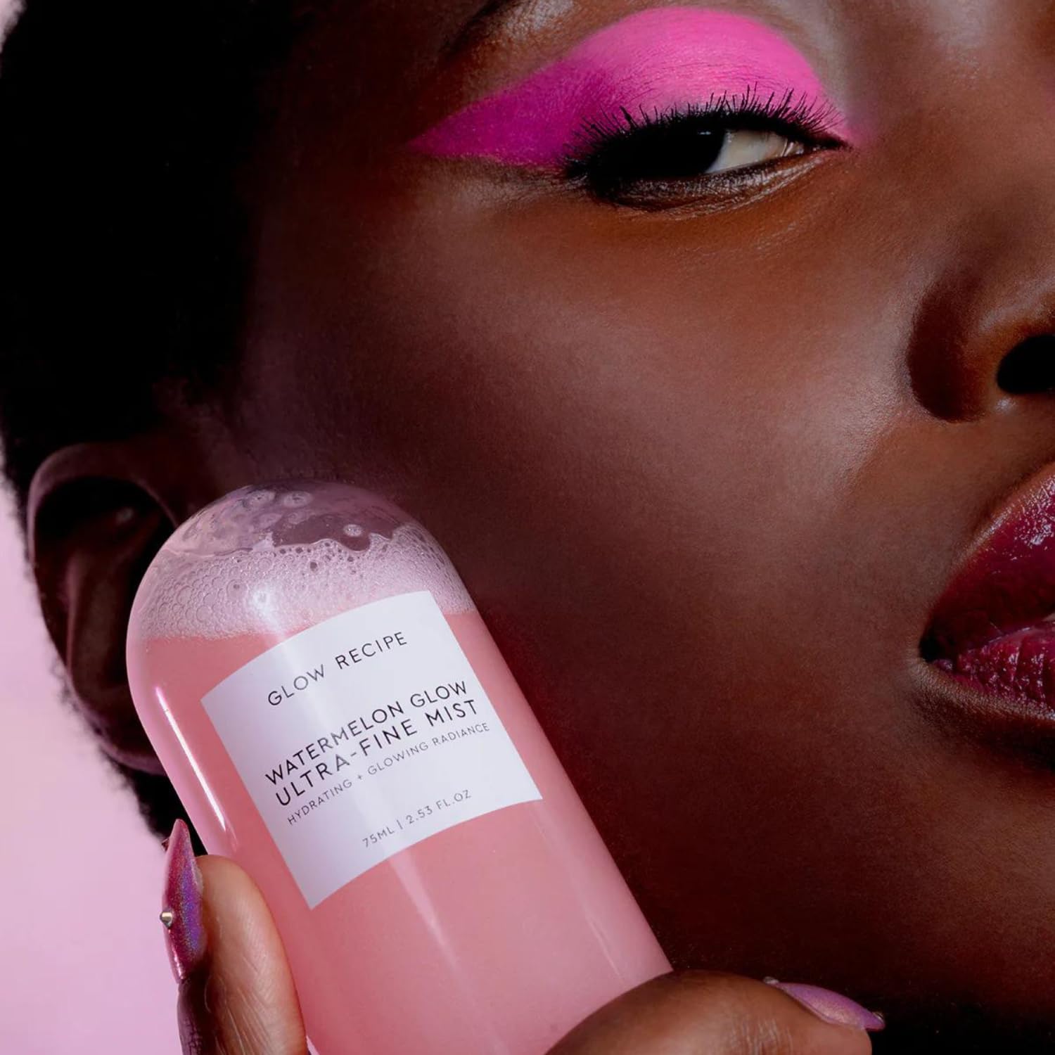 Glow Recipe facial spray bottle alongside real fresh watermelon pieces
