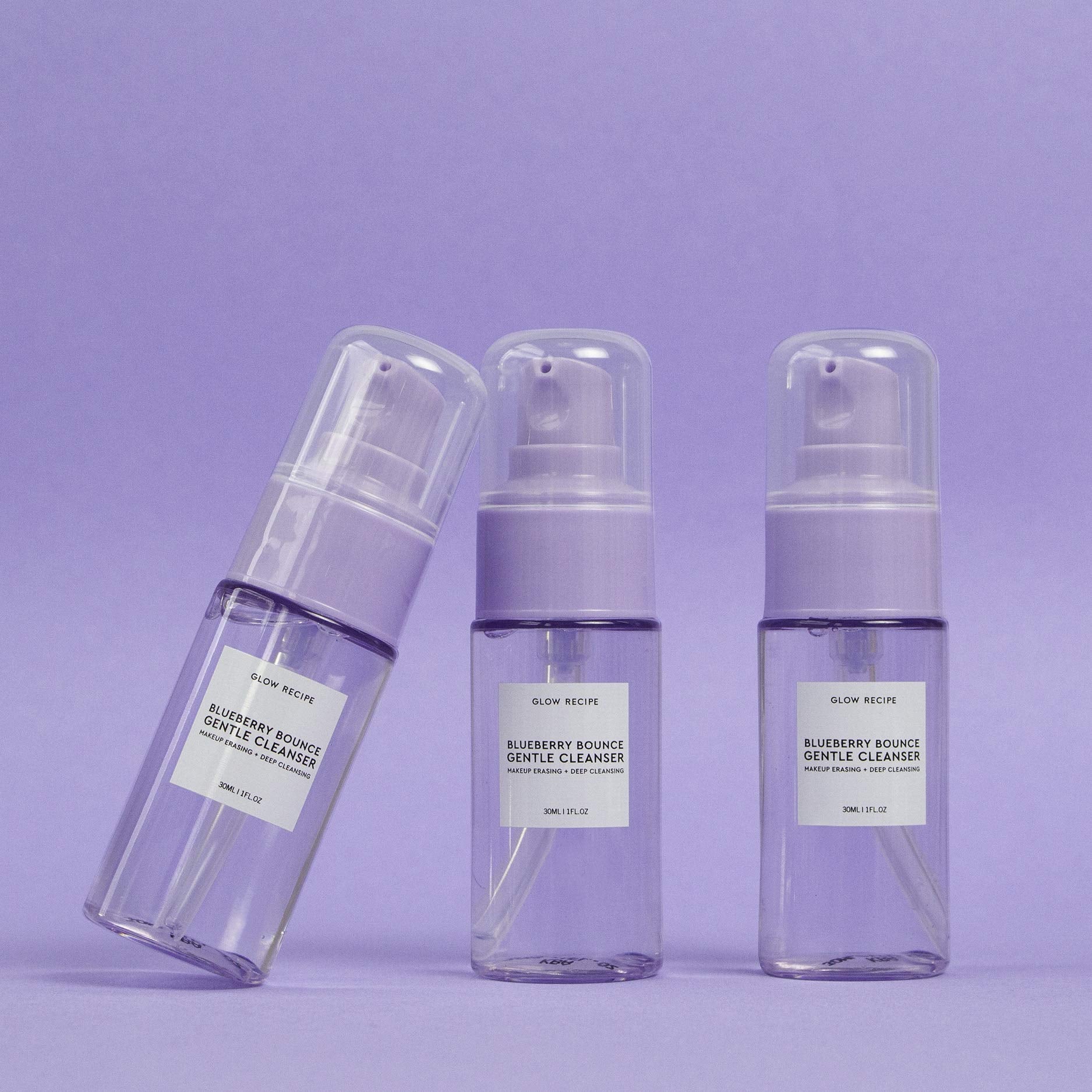 Side profile of Glow Recipe 30ml transparent bottle revealing the purple hued gel cleanser inside