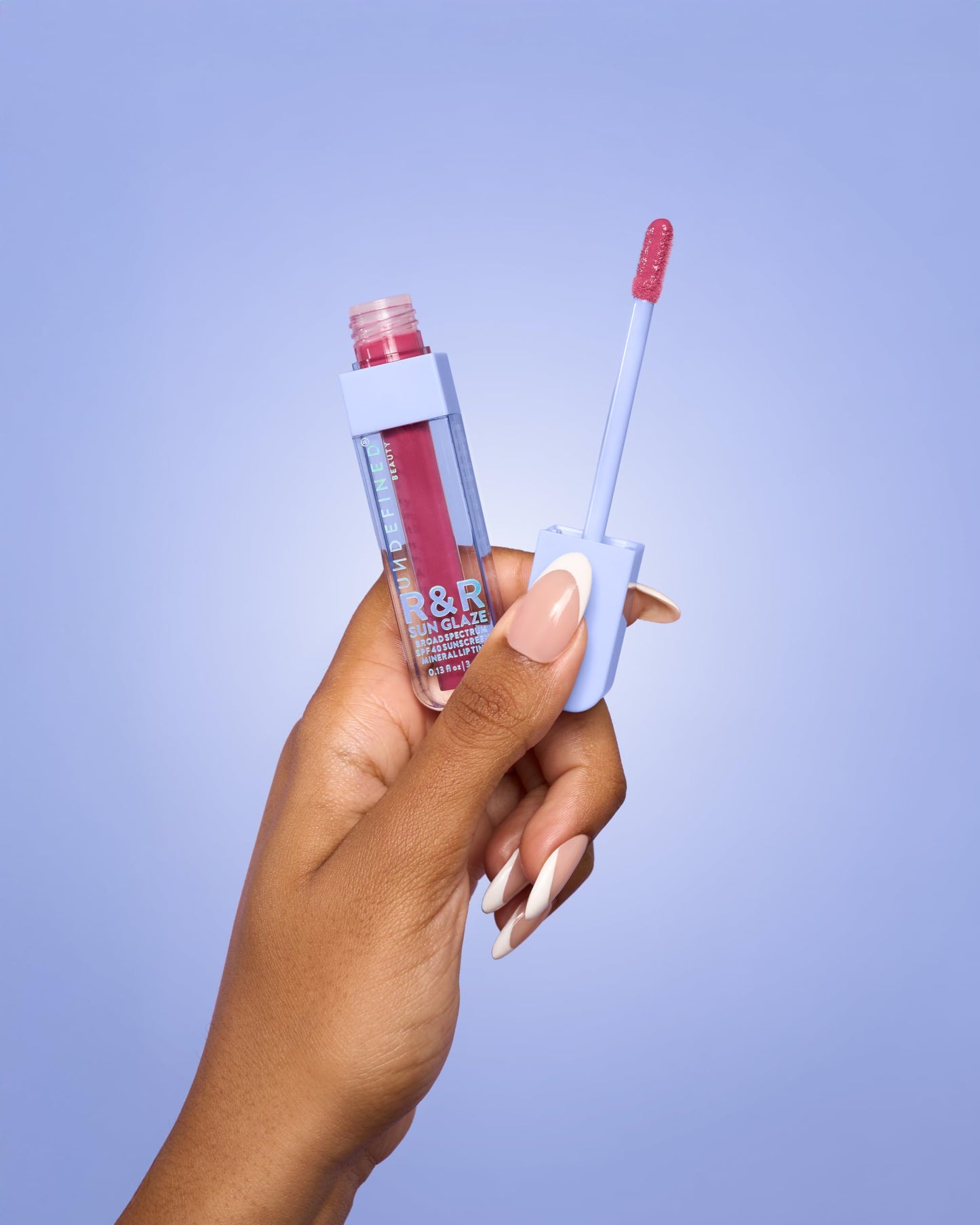 Model wearing Undefined R&R Sun Glaze Pink lip tint
