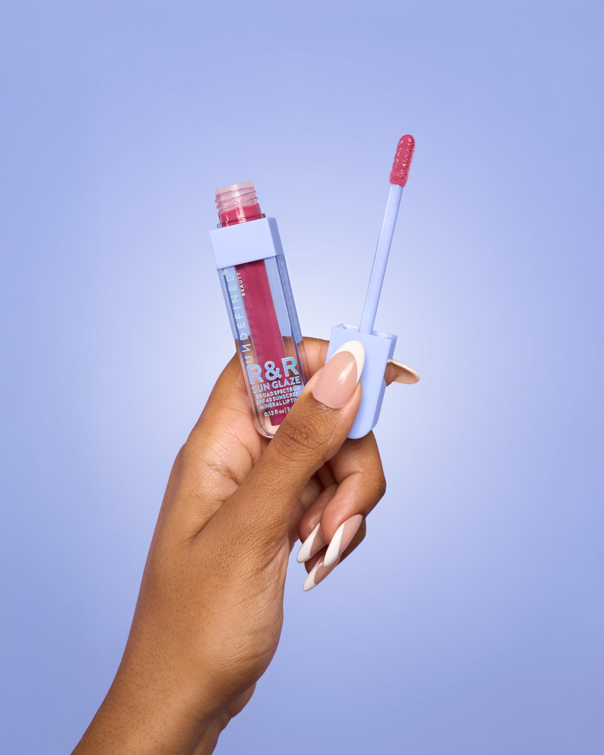 Model wearing Undefined R&R Sun Glaze Pink lip tint