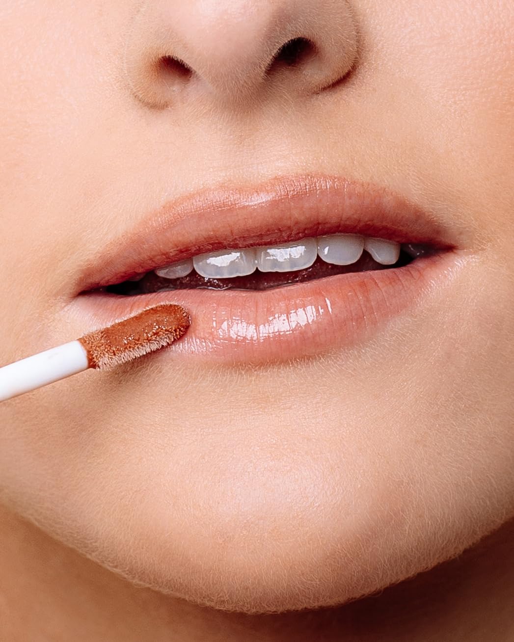 Close up of Naked Sundays SPF 50 lip oil bottle