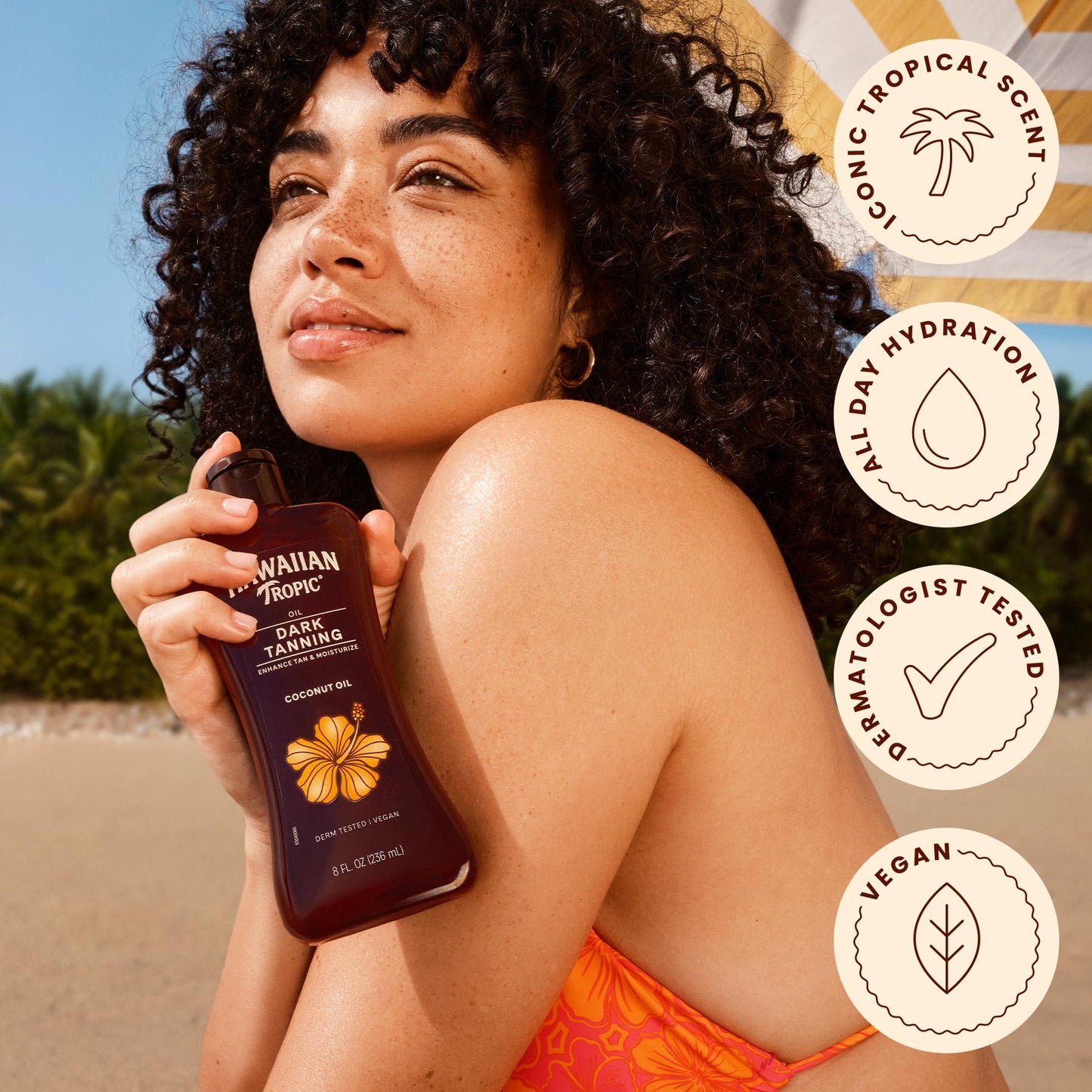 Two bottles of Hawaiian Tropic tanning oil with coconut and cocoa butter