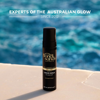 Bondi Sands Liquid Gold bottle next to tanning application mitt