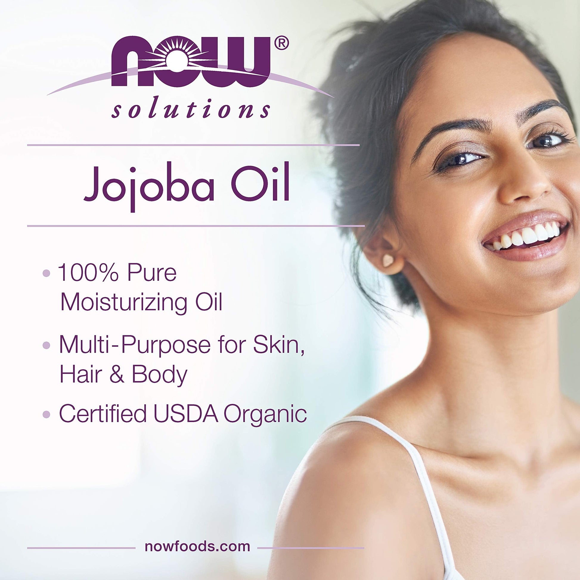 NOW Foods organic jojoba multi-purpose oil being dispensed demonstrating its smooth golden texture.
