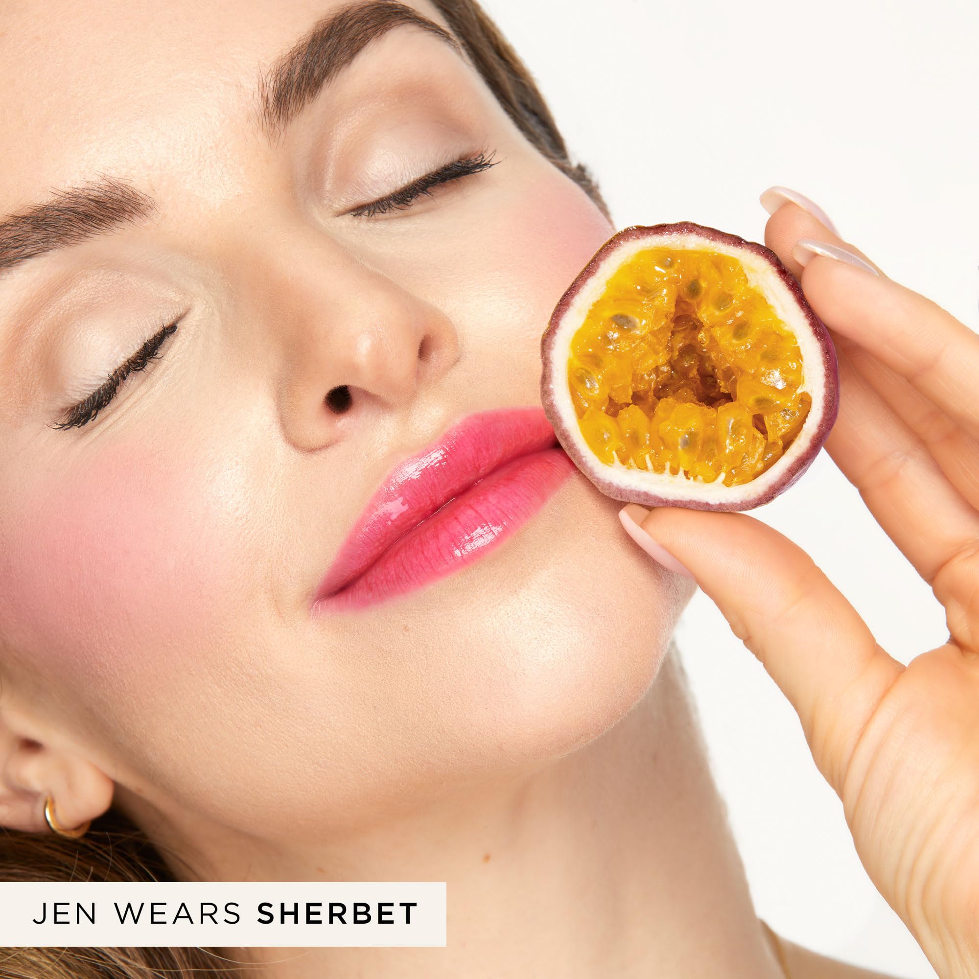 Model applying Tarte juicy shift as a cheek blush
