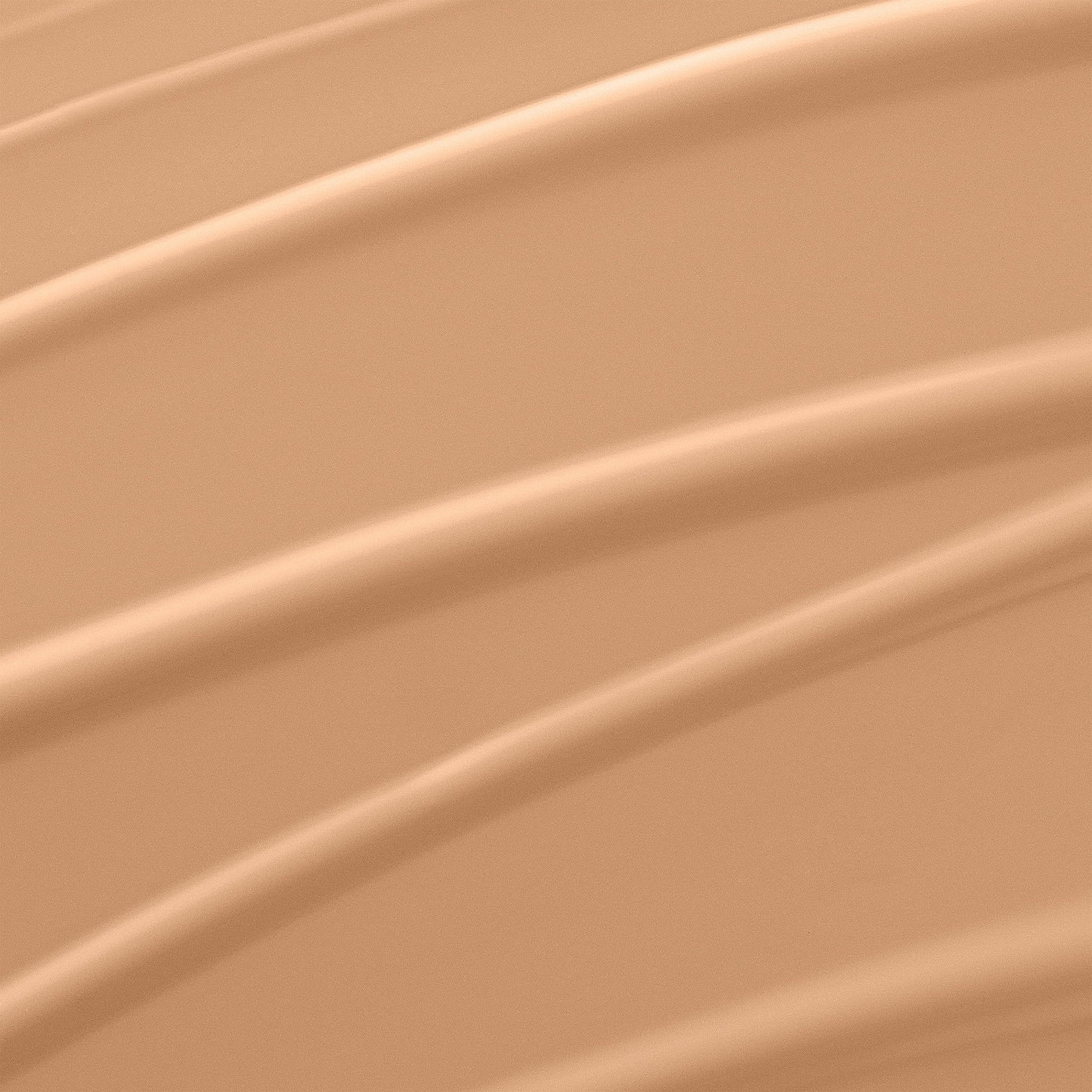 Lancome liquid foundation bottle showing the clear product shade and white cap closure