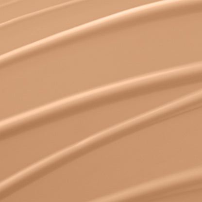 Lancome liquid foundation bottle showing the clear product shade and white cap closure
