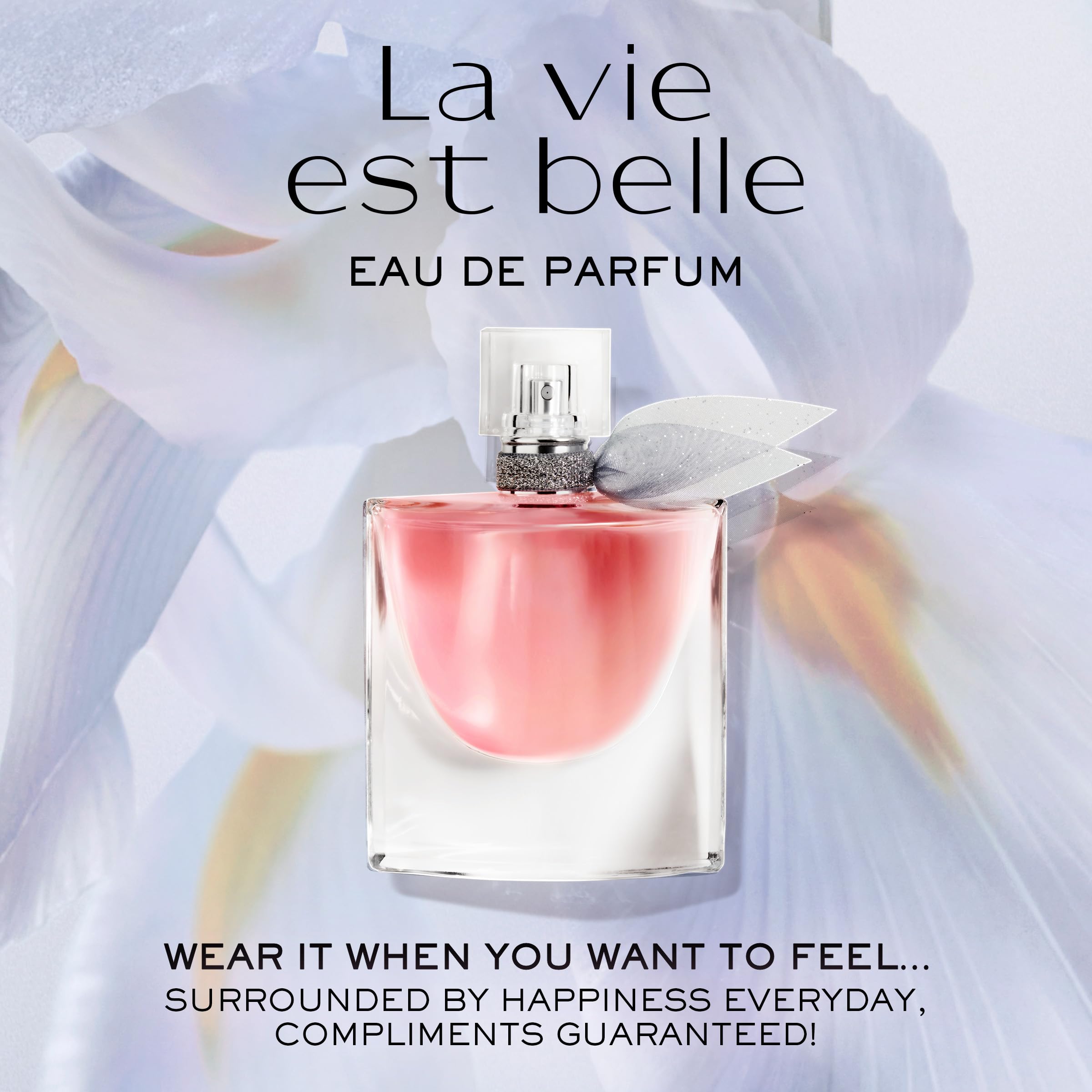 Compact Lancôme long lasting fragrance bottle being placed inside a small designer handbag
