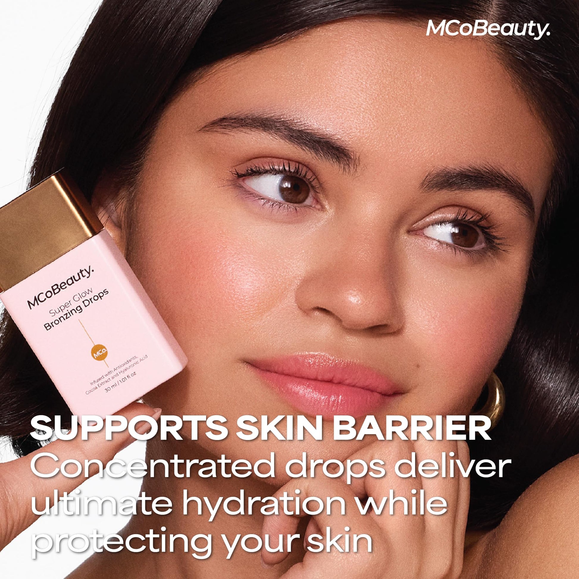 MCoBeauty multi use bronzing drops applied on the back of a hand demonstrating the blendable dewy finish.