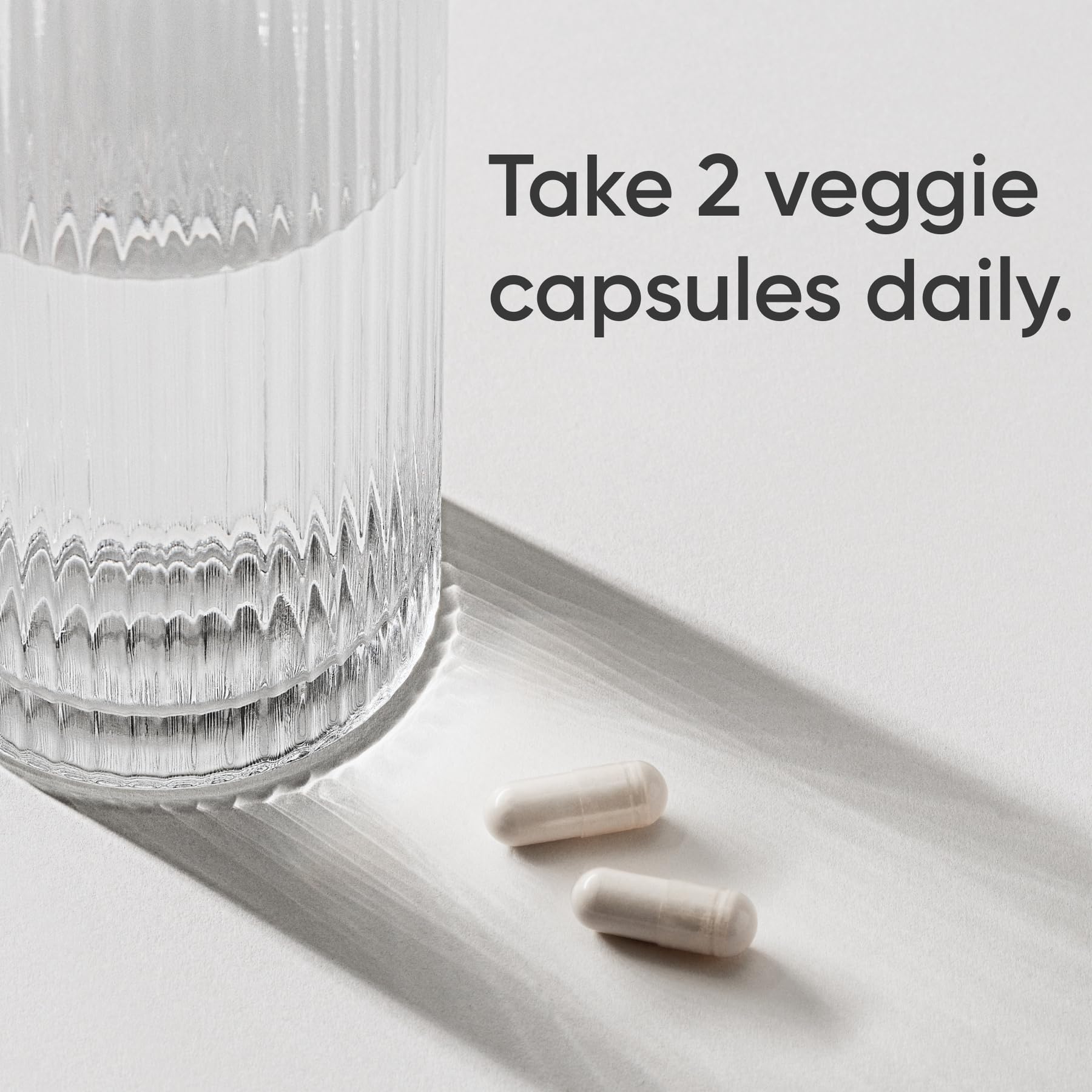 Side view of Sports Research vegan magnesium glycinate bottle showing non-GMO verified badges.