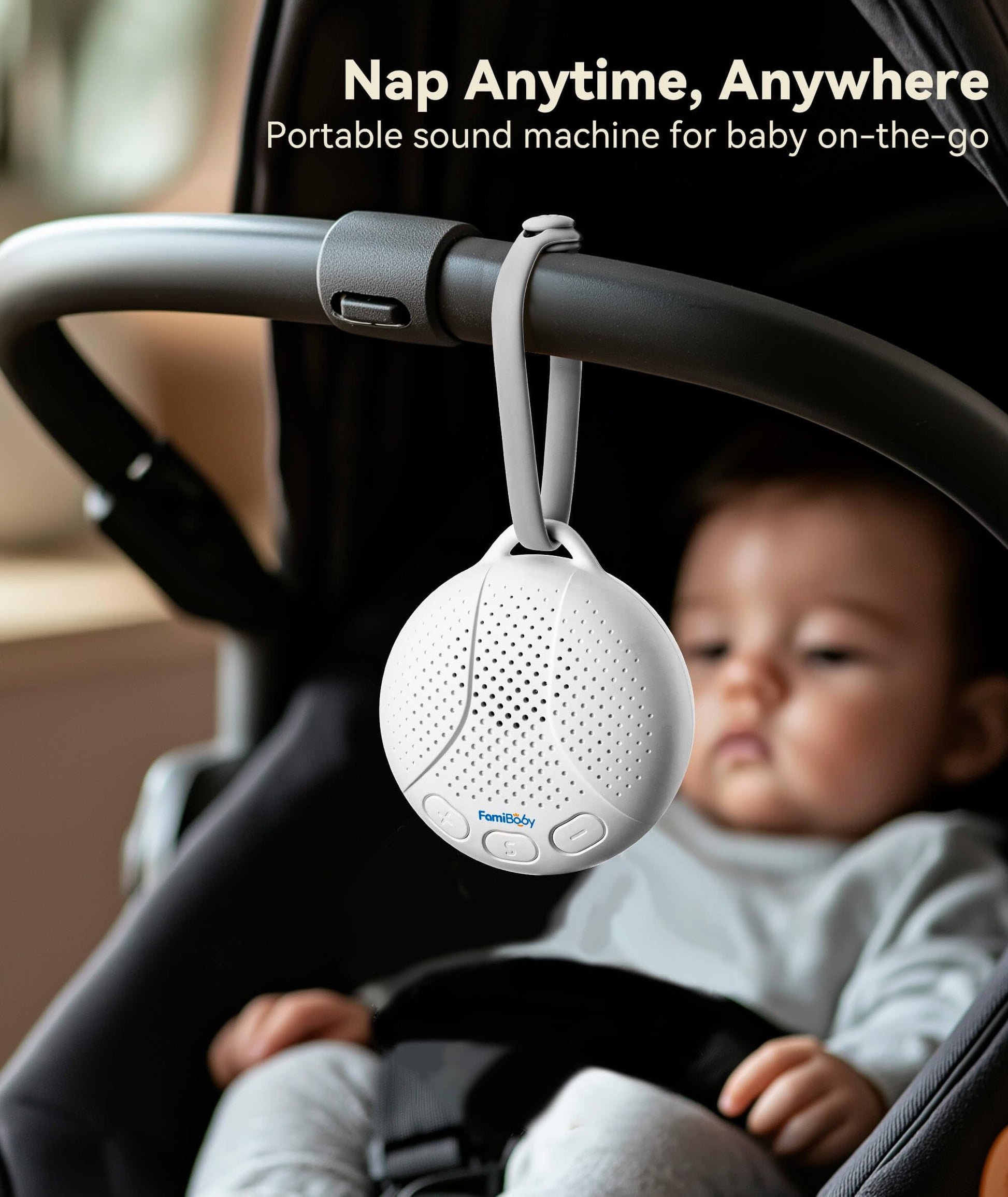 FamiBaby infant sleep soother attached to a stroller handlebar using its flexible travel strap.