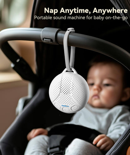 FamiBaby infant sleep soother attached to a stroller handlebar using its flexible travel strap.