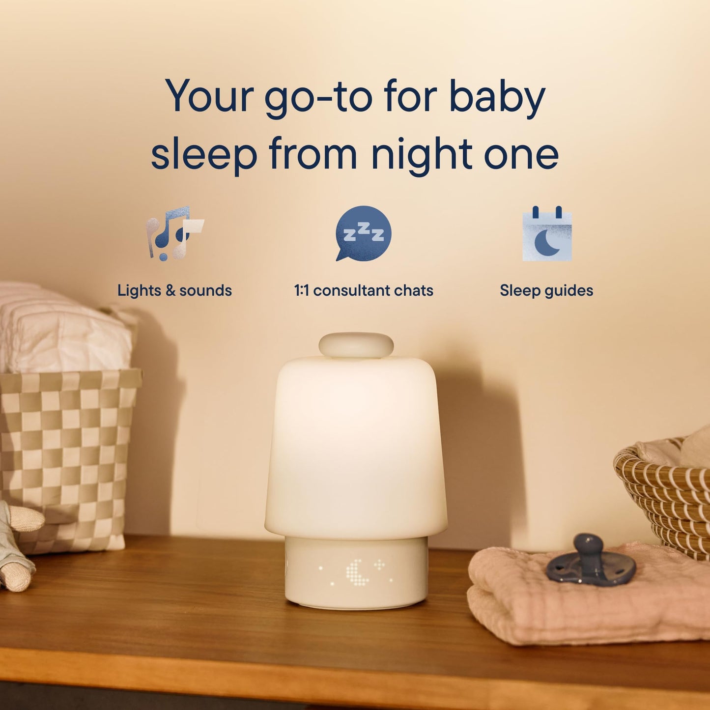 Hatch Baby white noise machine glowing with soft night light colors for baby bedtime routines.