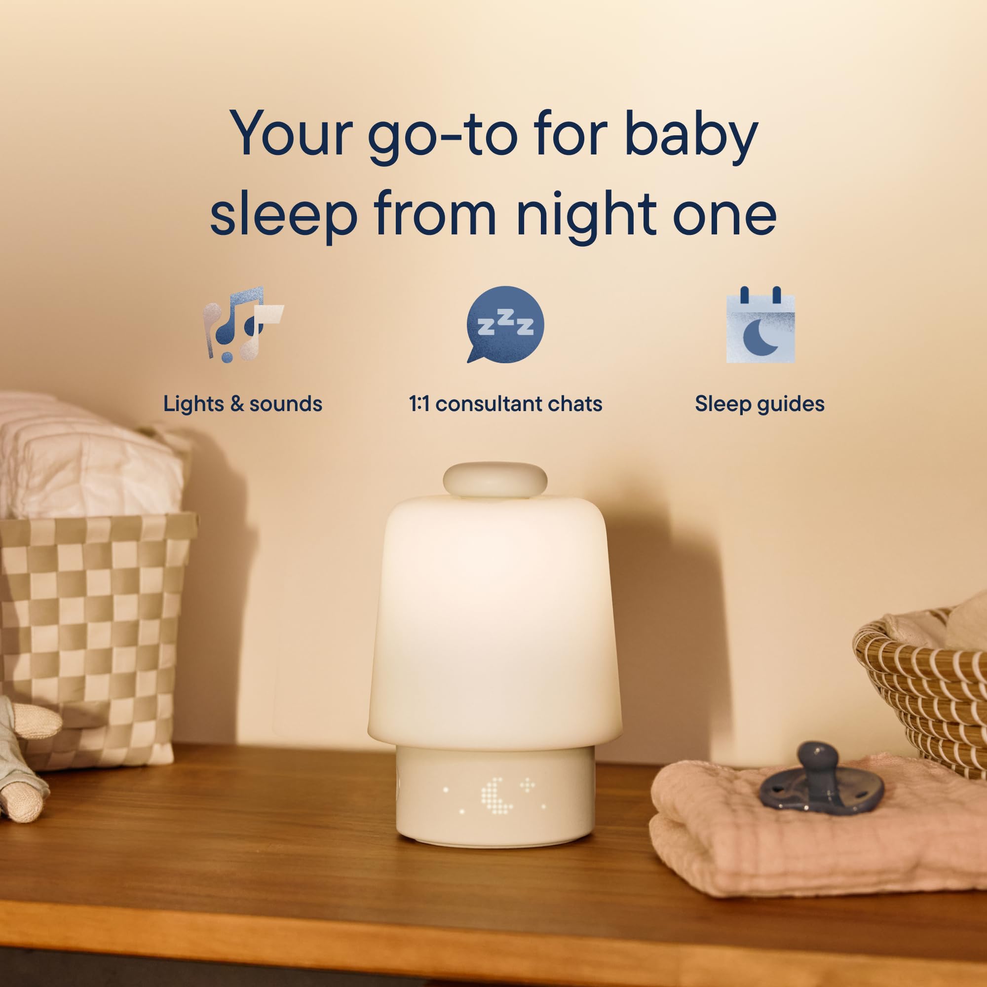 Hatch Baby white noise machine glowing with soft night light colors for baby bedtime routines.