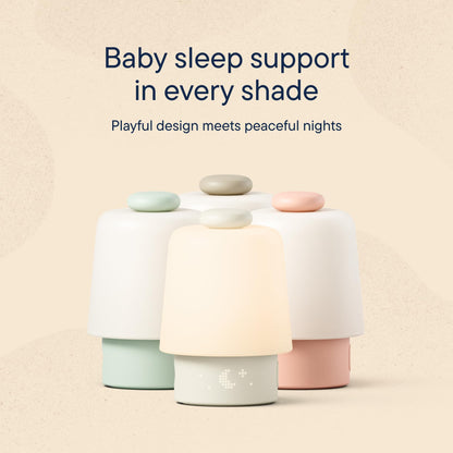 Hatch Baby Rest smart sound machine placed safely three feet away from a cozy infant crib.