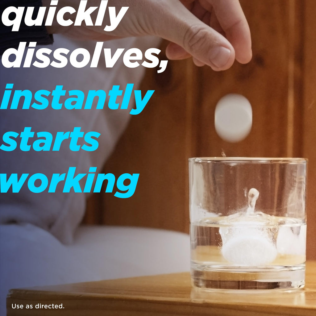 Alka-Seltzer tablets dissolving in a glass of water