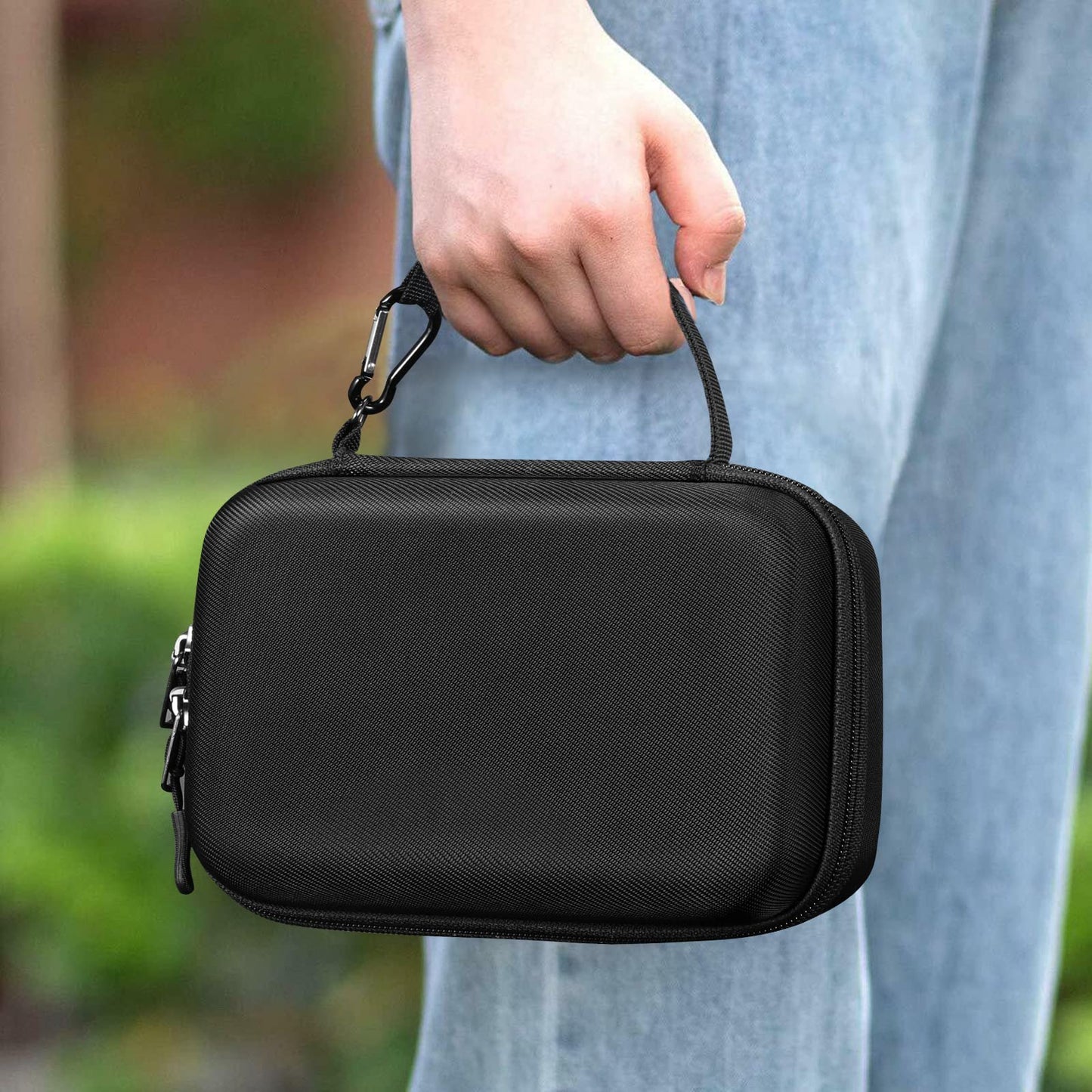 Elonbo handheld atomizer travel case being carried by the convenient wrist strap